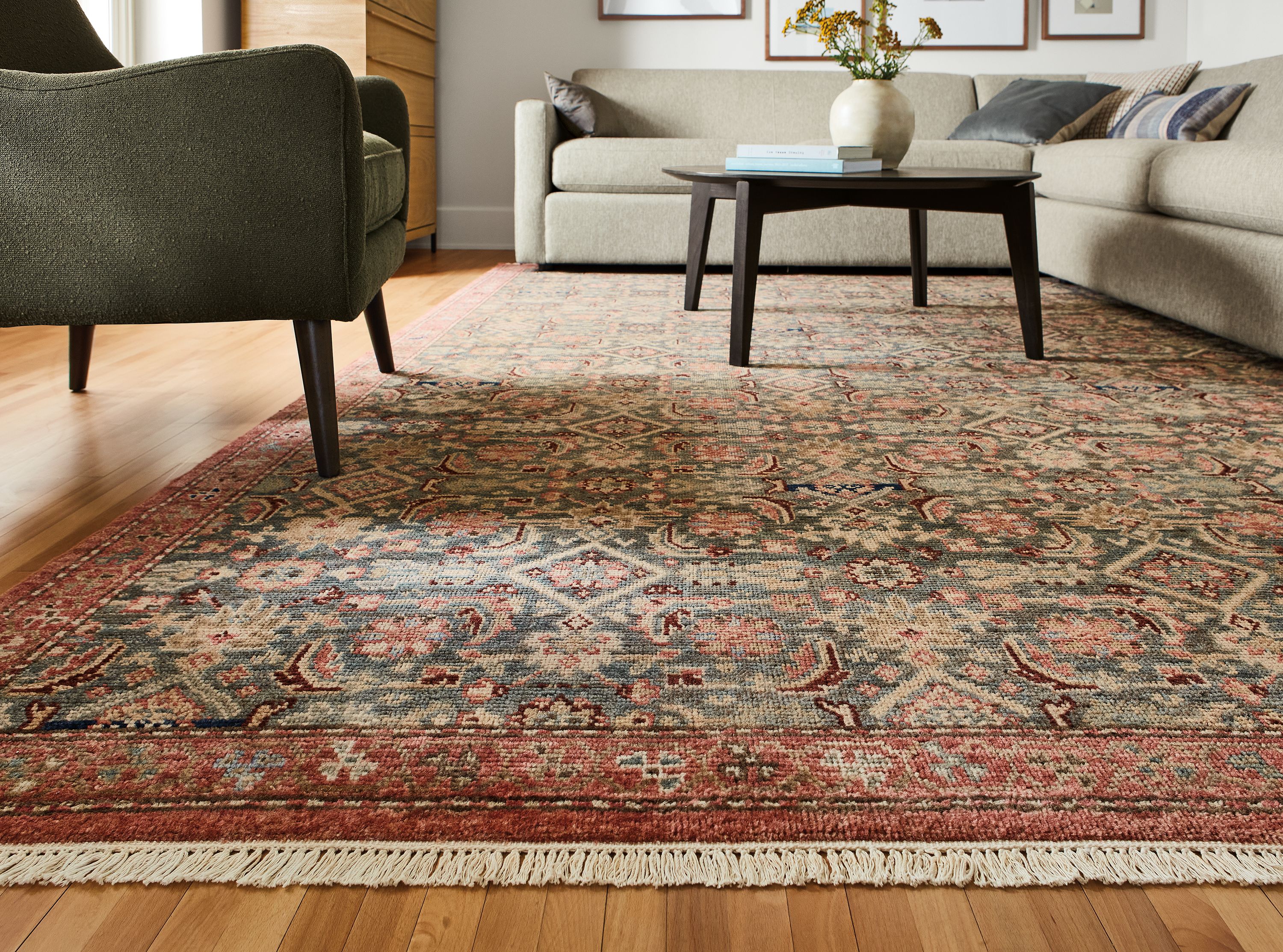 Detail of Helena rug in slate, alex sectional, quinn chair and orlin coffee table.