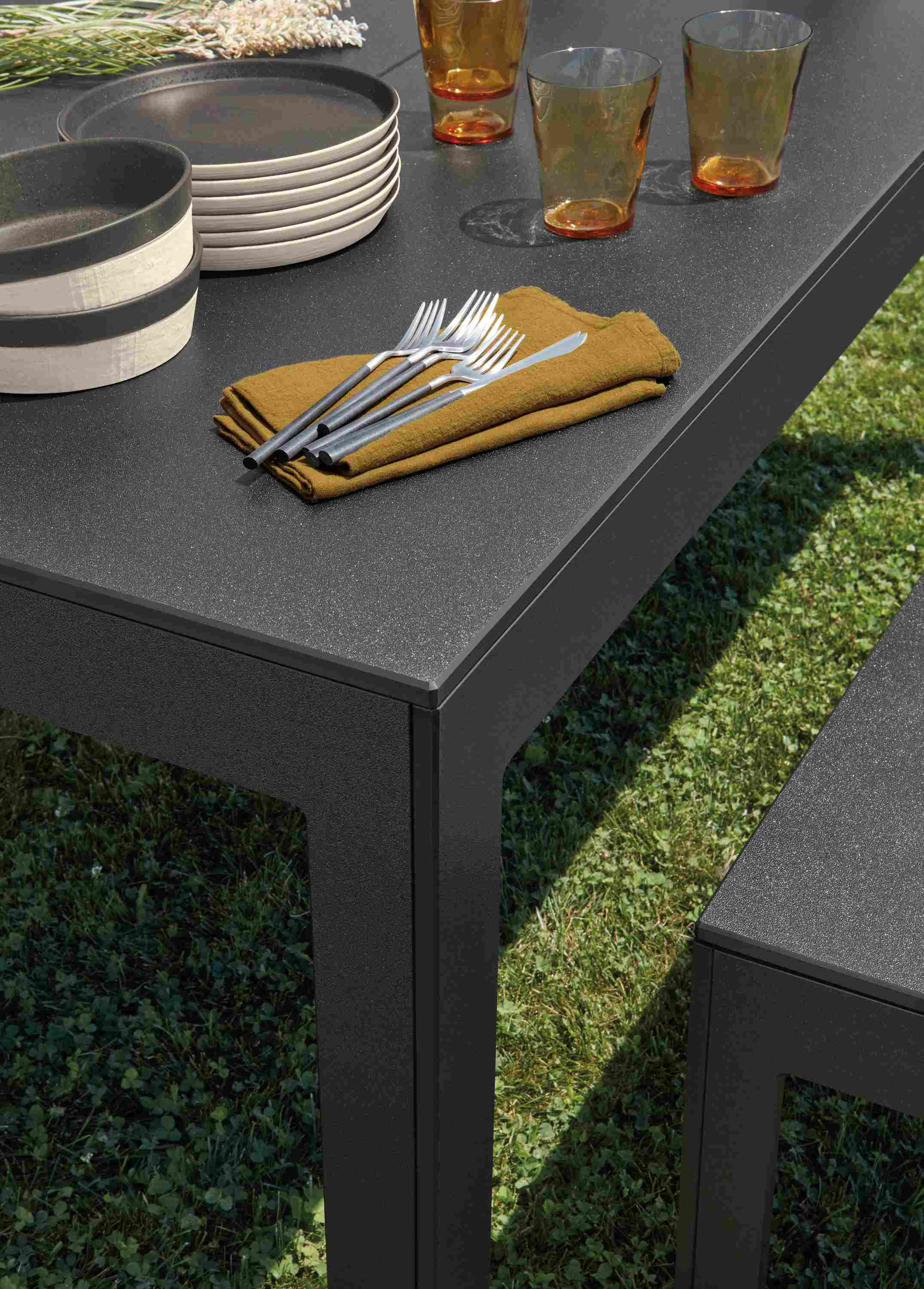 Closeup of Henry outdoor table and bench in black recycled HDPE.