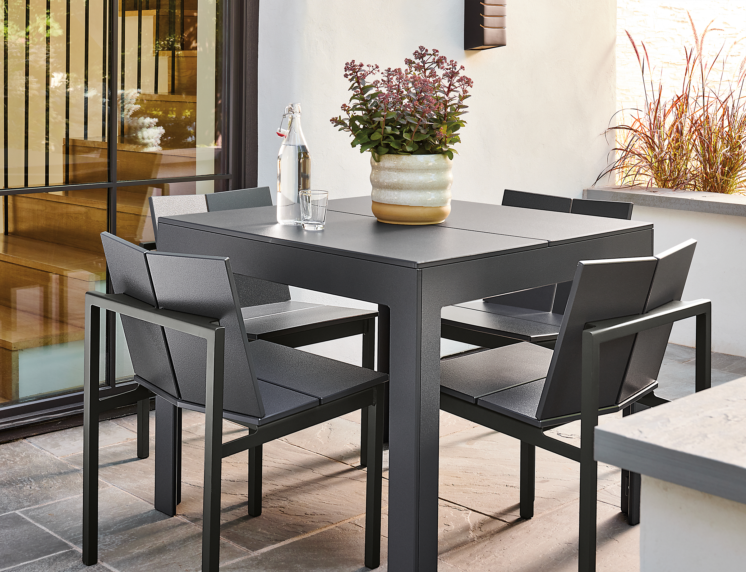 Outdoor space with henry table in grey, mattix side chairs, elias planter.