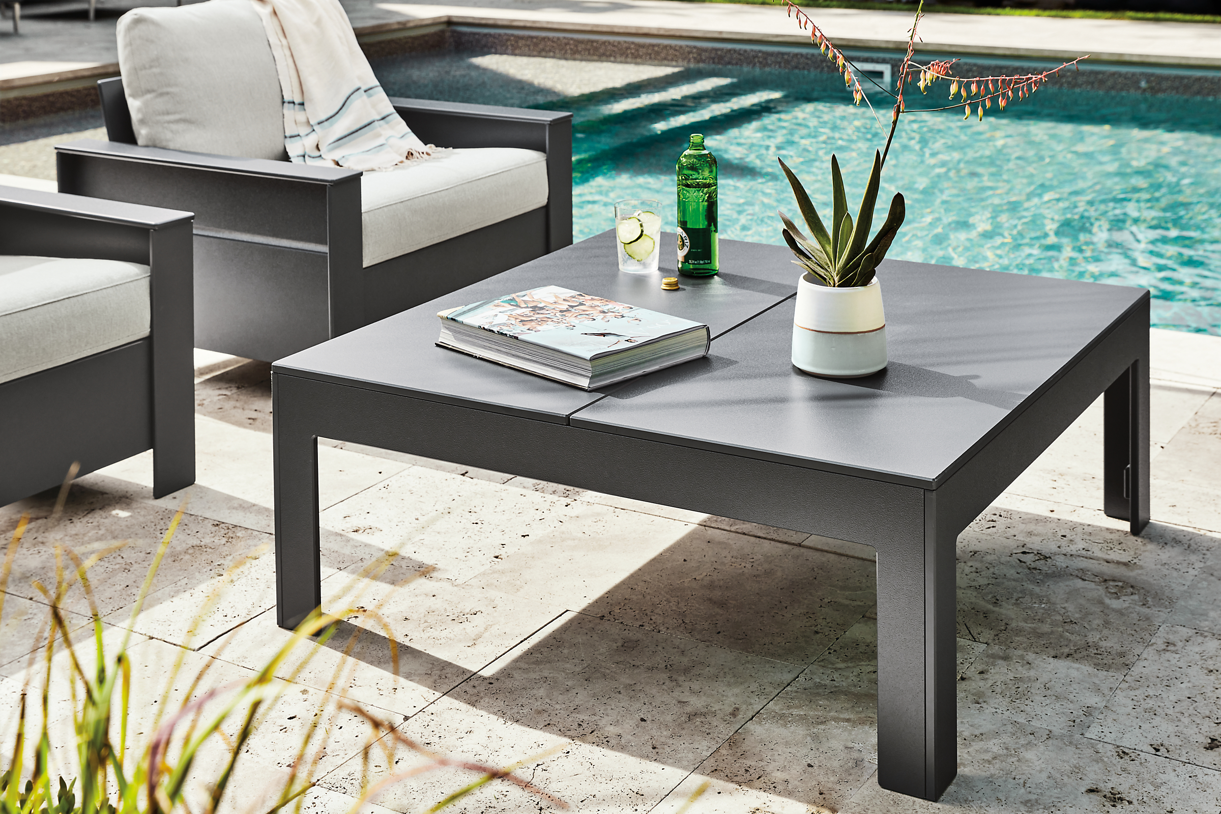 Henry 42-square outdoor coffee table in grey with two Rayo lounge chairs in grey with Mist grey cushions.