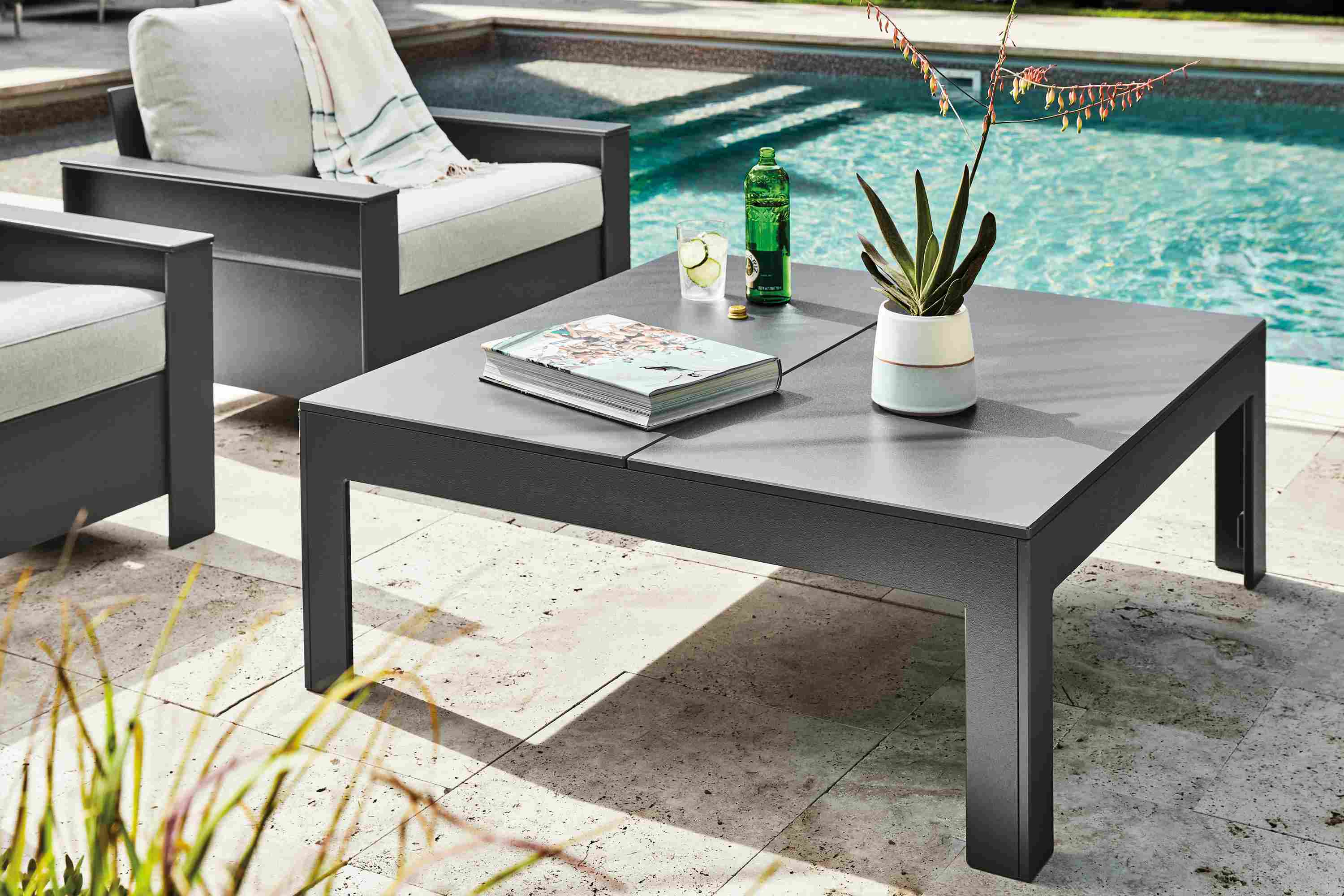 Henry 42-square outdoor coffee table in grey with two Rayo lounge chairs in grey with Mist grey cushions.