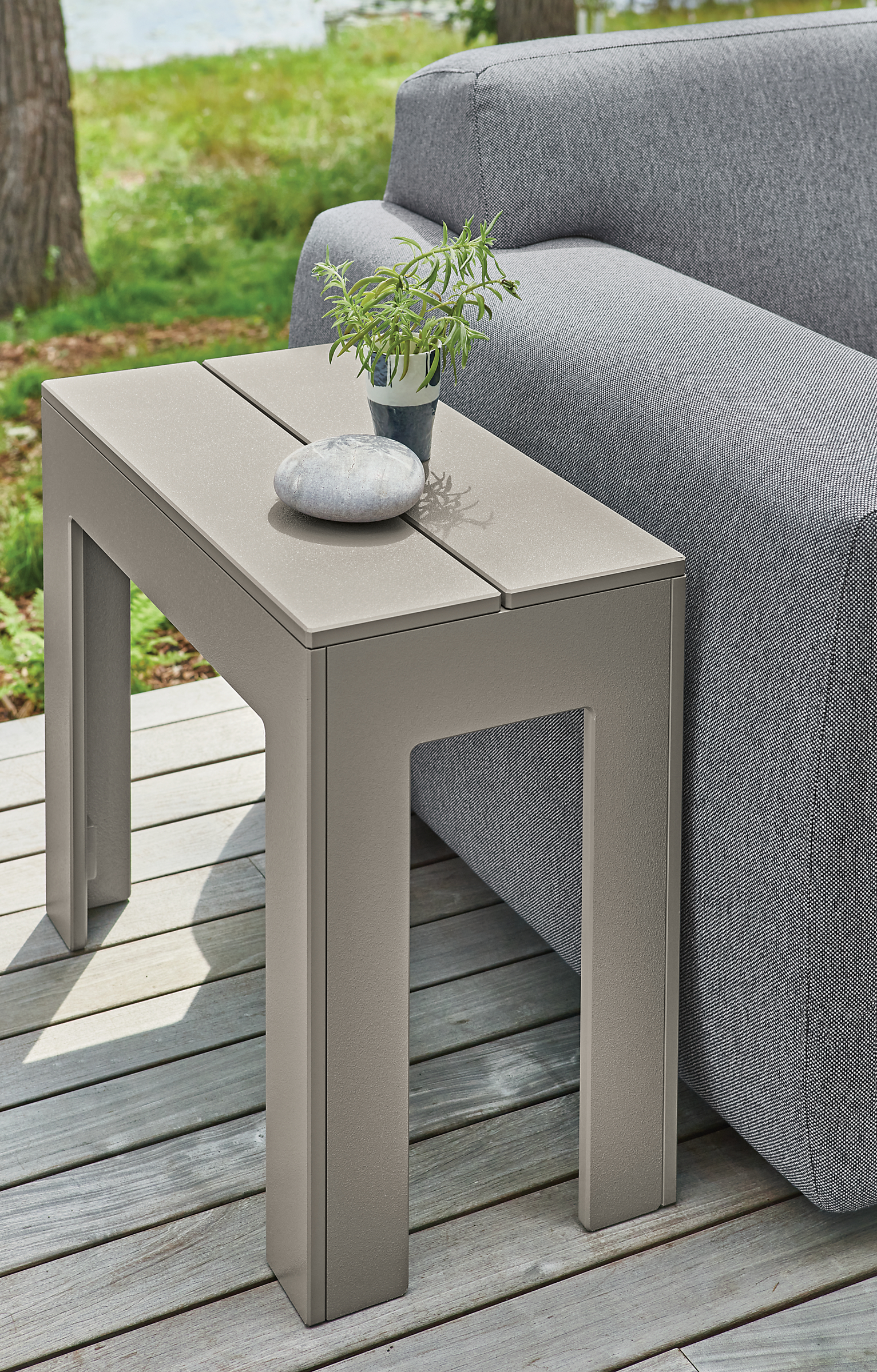 Detail of Henry side table in Putty beside Drift outdoor sofa.