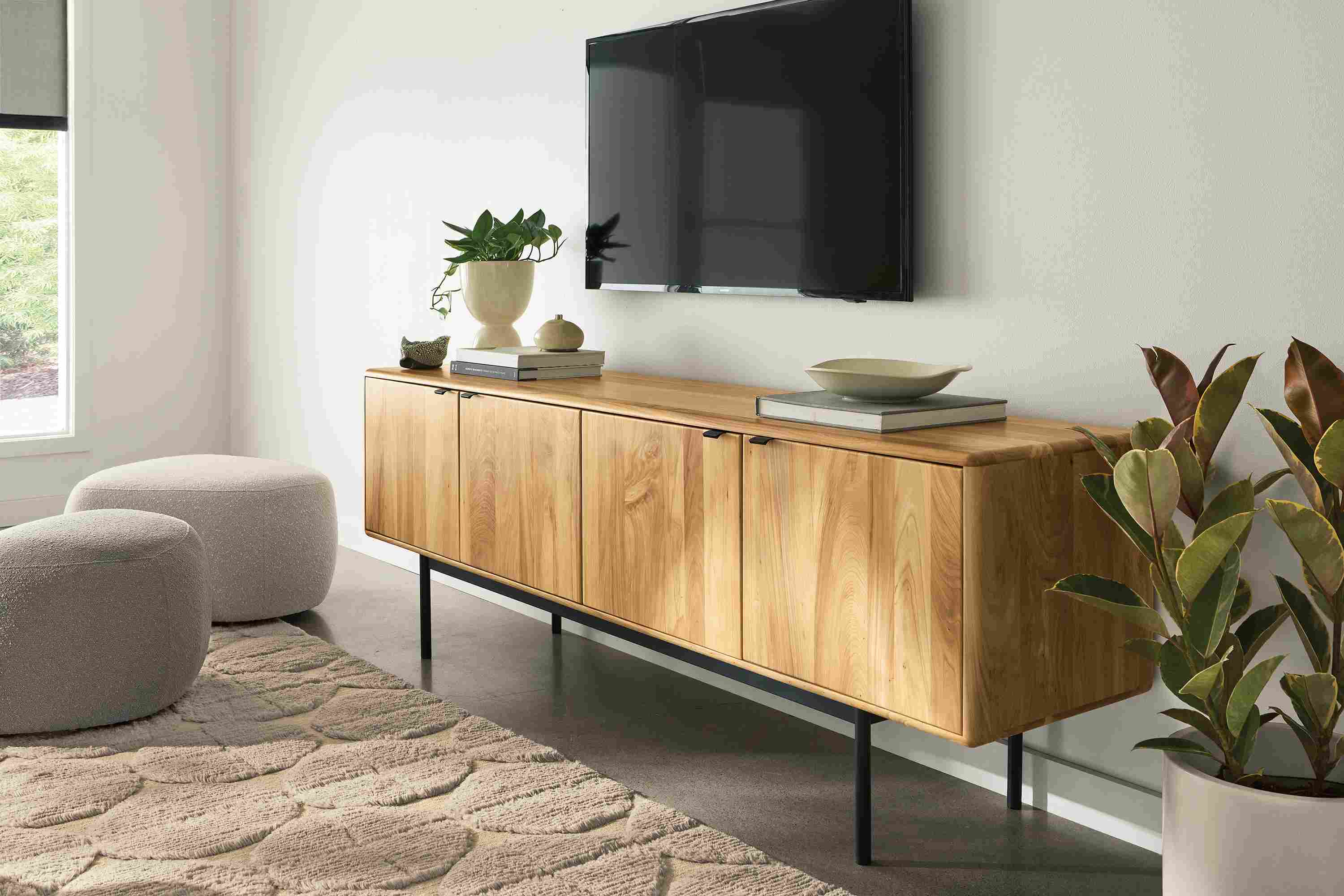 Living room with Hensley 80-wide media cabinet in reclaimed elm and Asher ottomans in Declan Putty and Declan Natural.