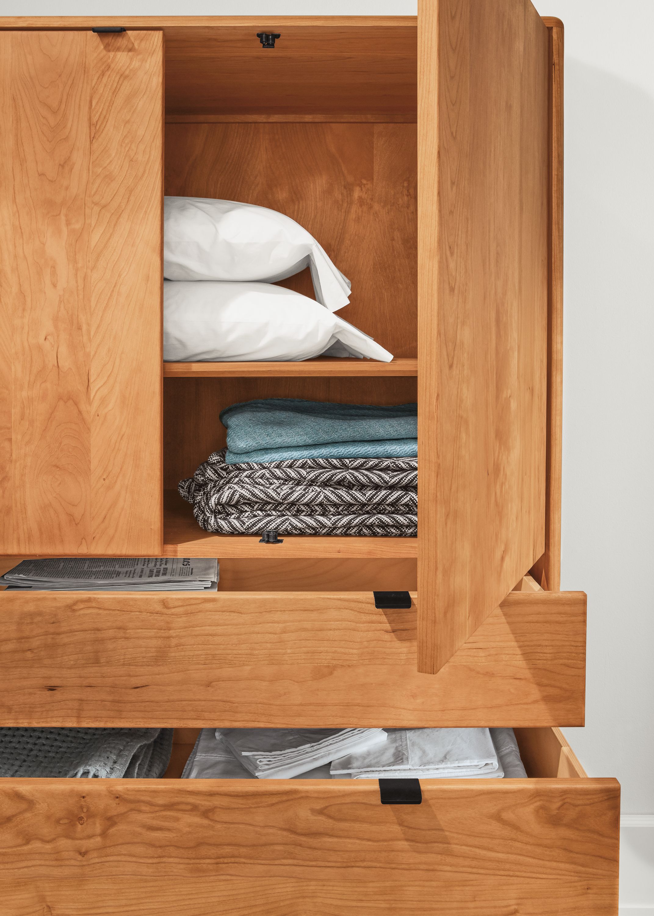 Detail of open Hensley three-drawer armoire.