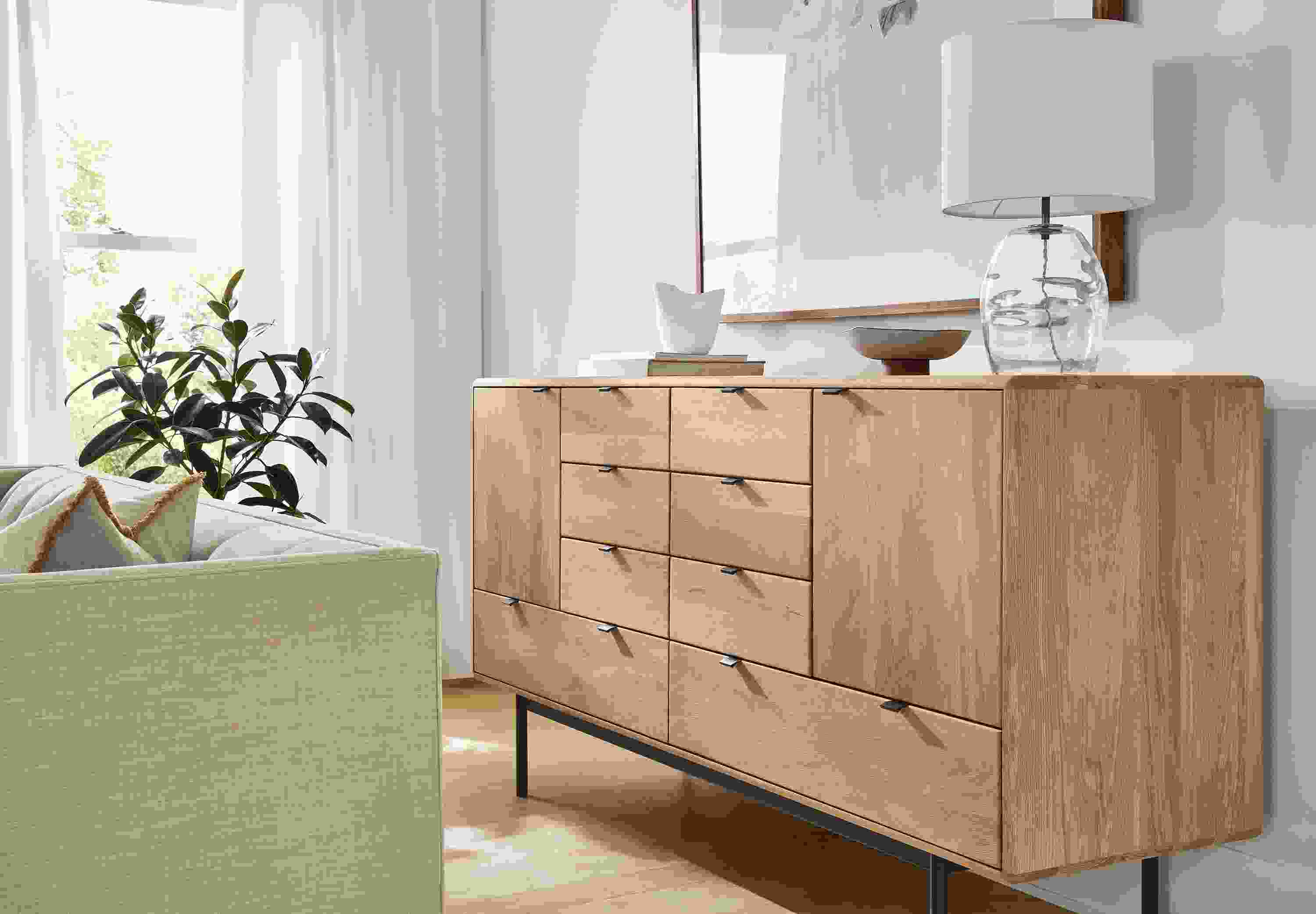 Living room with detail of hensley 8-drawer, 2-door dresser in rye on red oak.