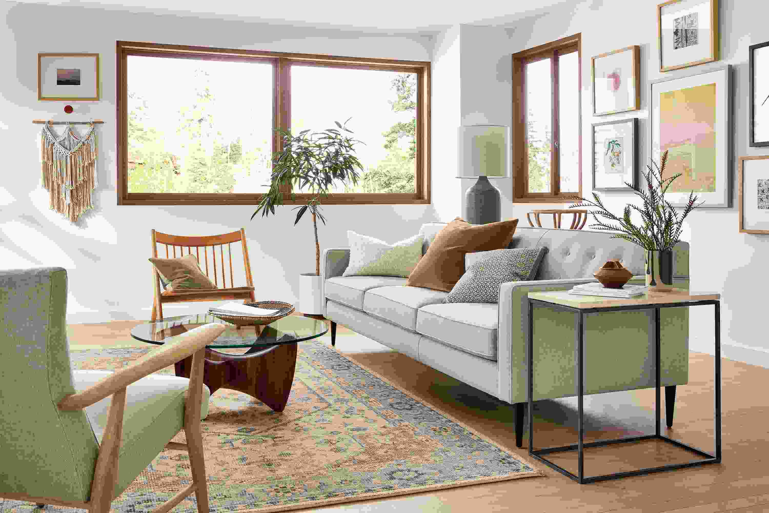 Living room with Holmes sofa and Jonas lounge chair both in sumner linen and Veda 6 by 9 rug in Camel.