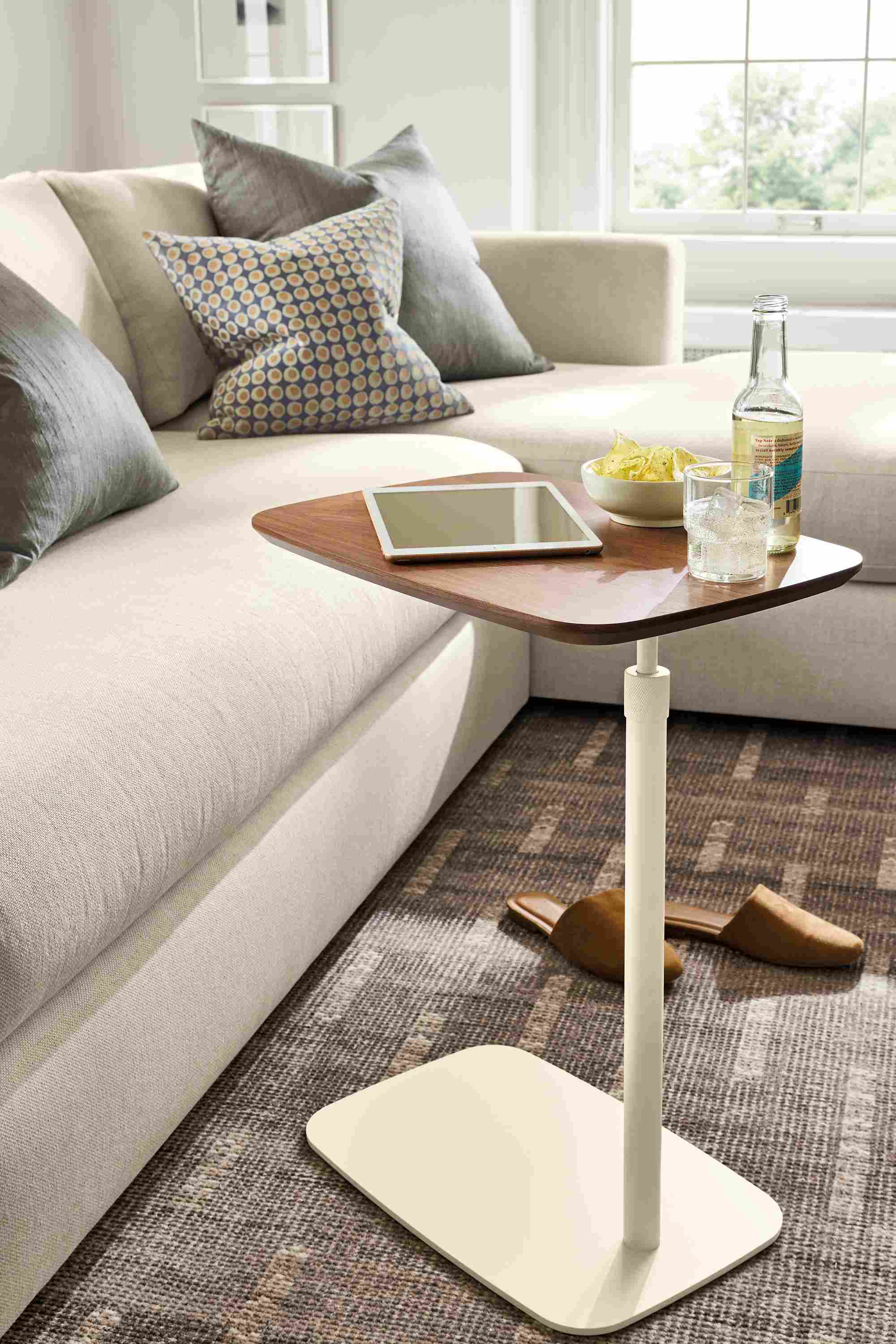 Living room with Hopper c-table in bisque and walnut, Hannah sofa in Sumner Ivory and Baran rug in grey.