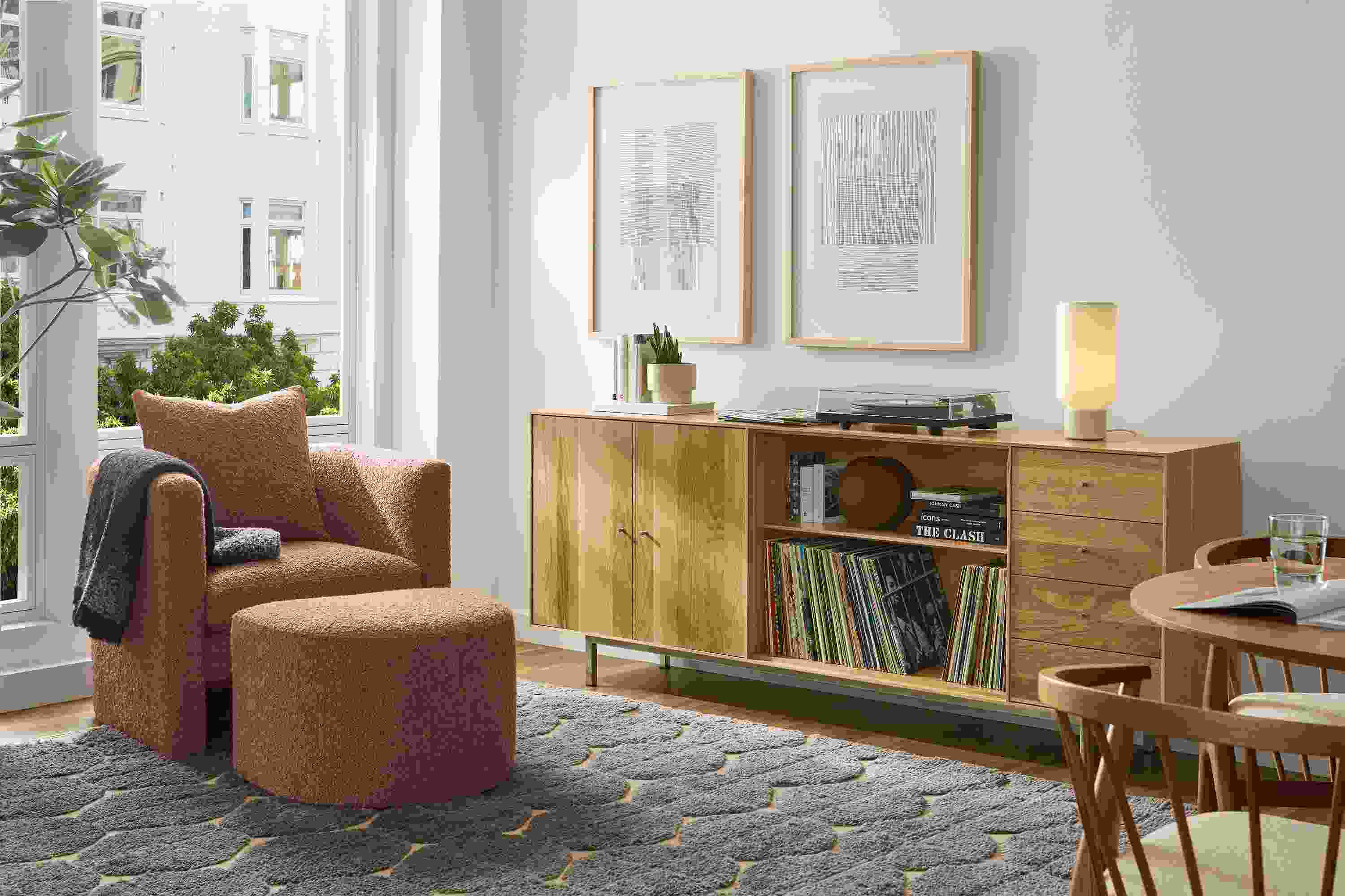 Living room with Hudson custom 5-insert cabinet in white oak and Silva chair and ottoman in dornick claystone.