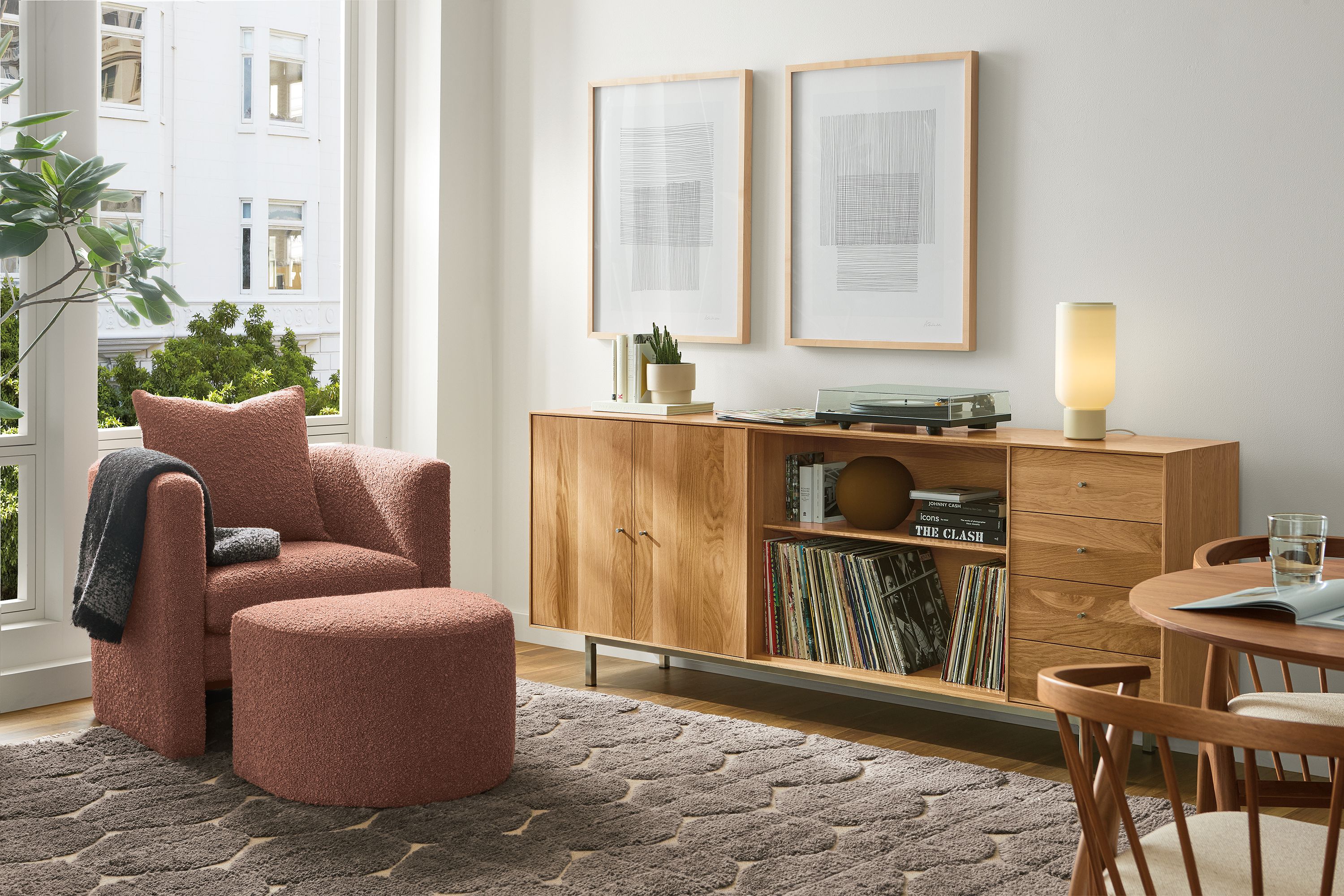 Living room with Hudson custom 5-insert cabinet in white oak and Silva chair and ottoman in dornick claystone.