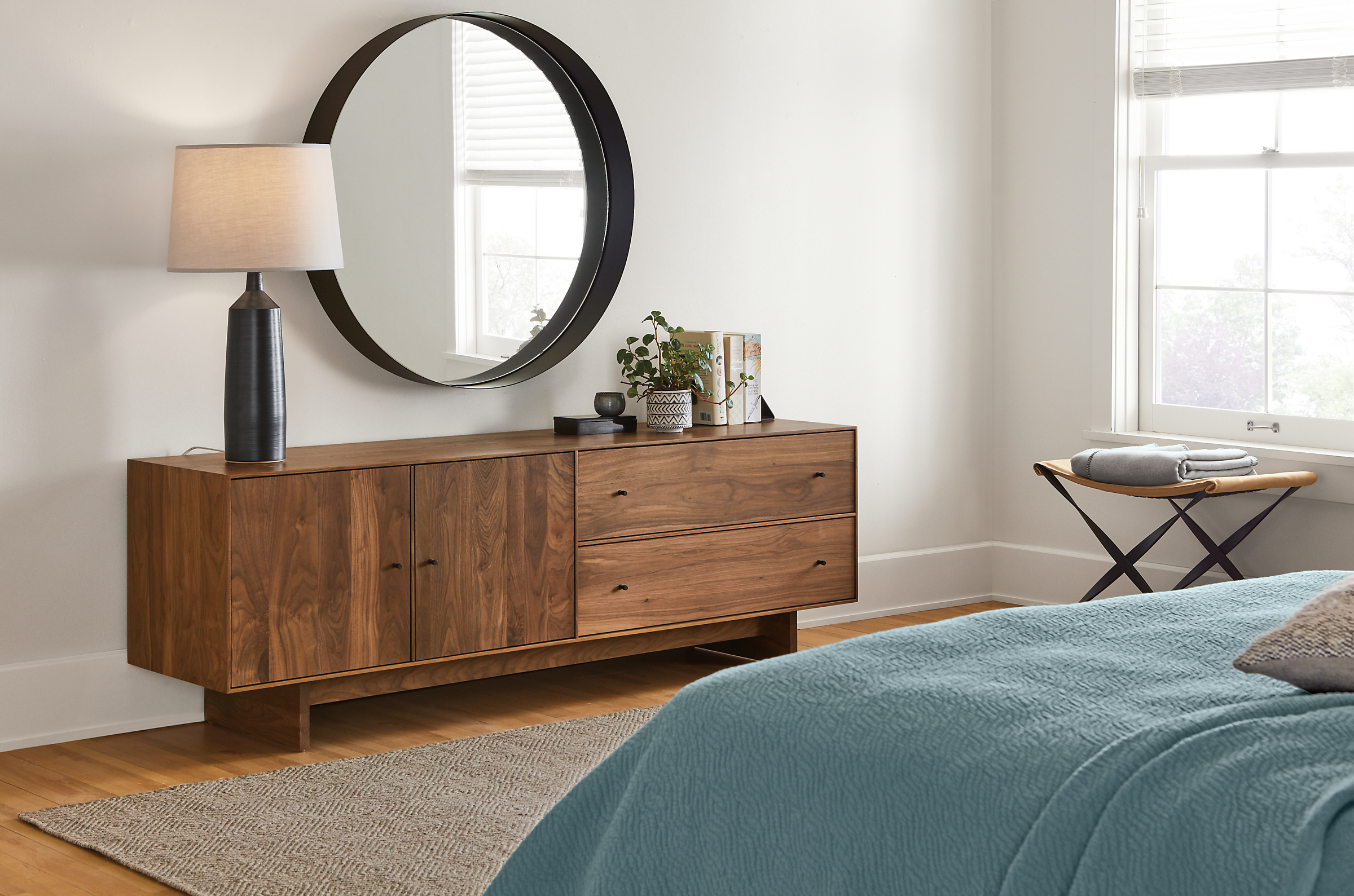 Detail of Hudson media cabinet with wood base in bedroom setting.