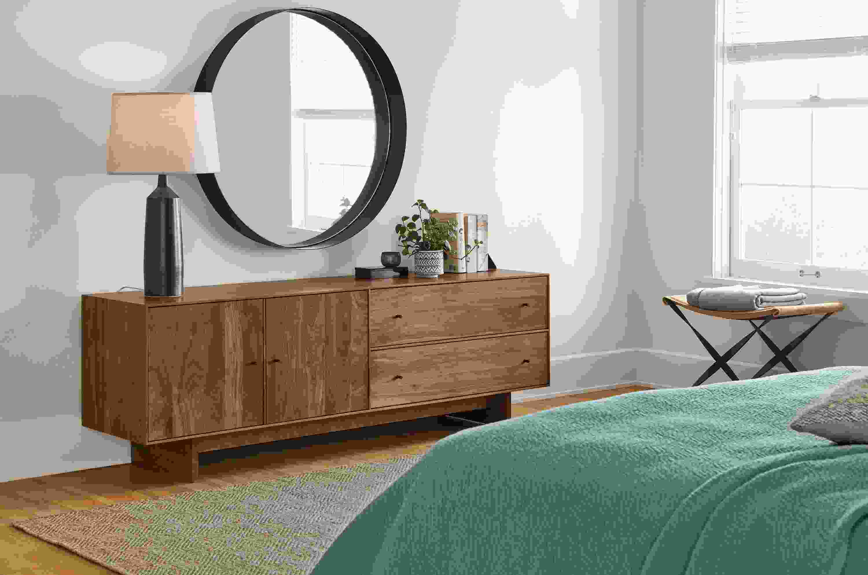 Detail of Hudson media cabinet with wood base in bedroom setting.