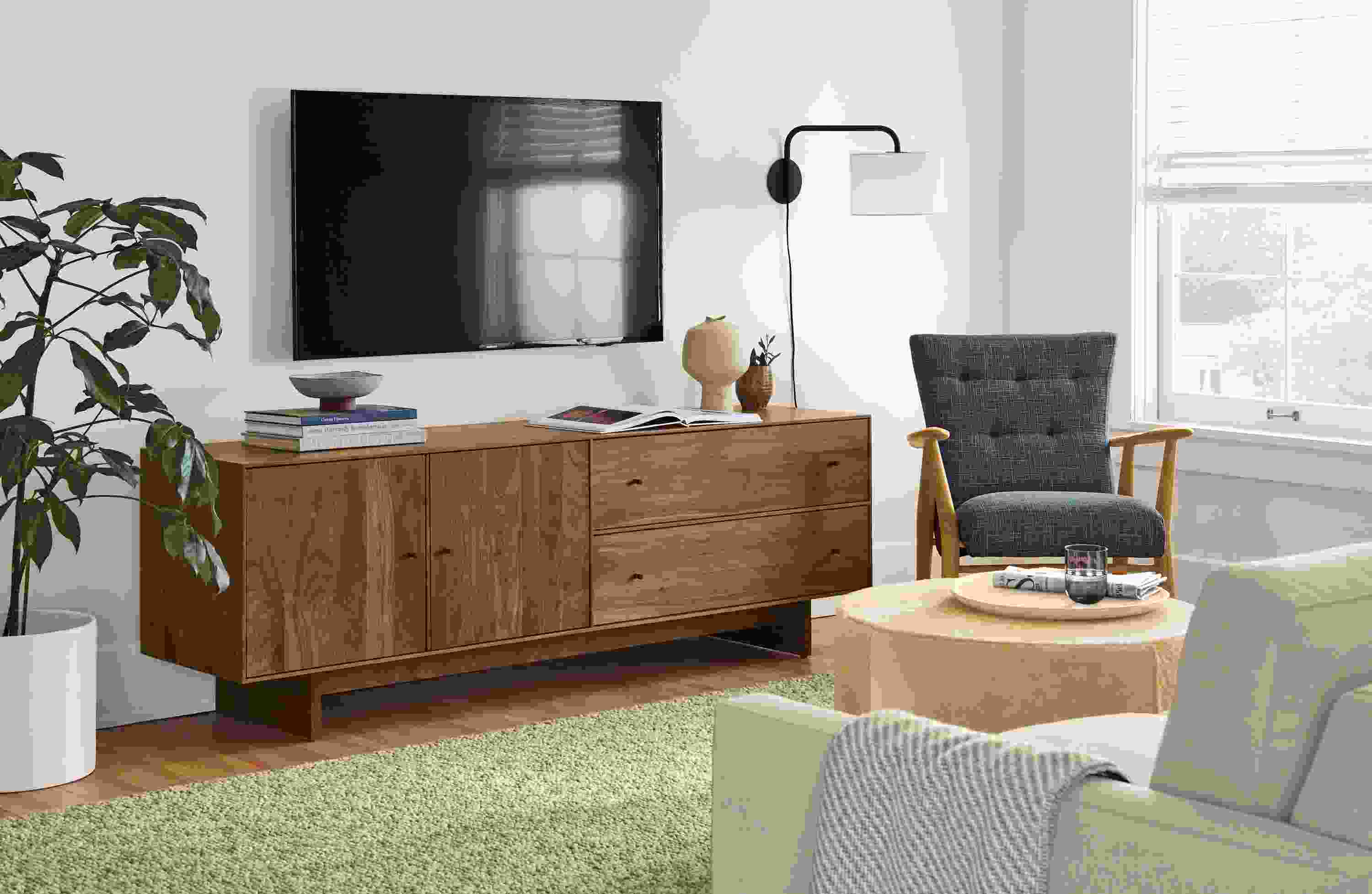 Detail of Hudson media cabinet with wood base in walnut.