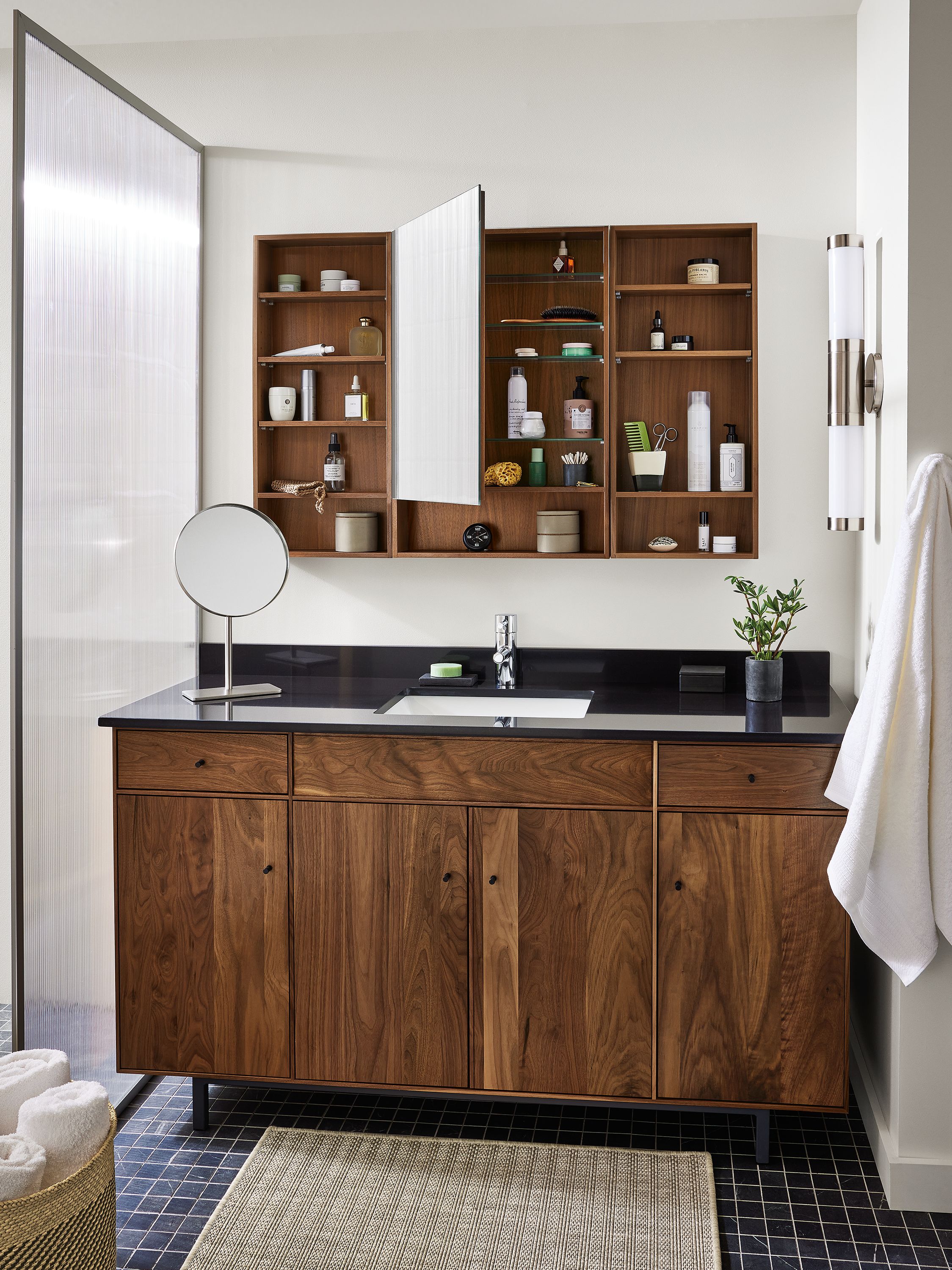 Bathroom with Hudson vanity in walnut and Bridger 46.5-wide medicine cabinet in walnut shown with open door.