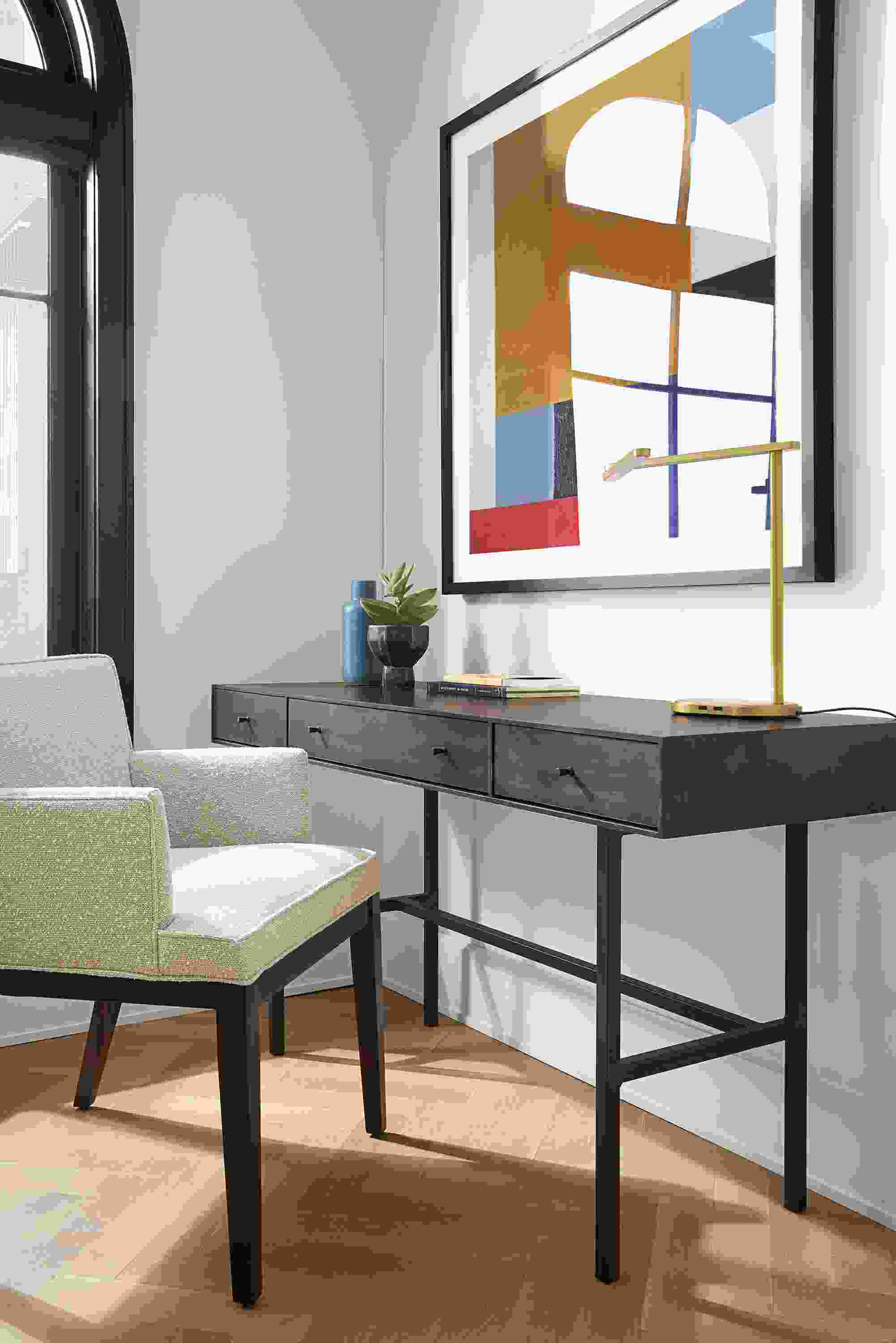 Home office area with Hudson 56-wide desk in charcoal on maple and pivot lamp in brushed gold powdercoat.
