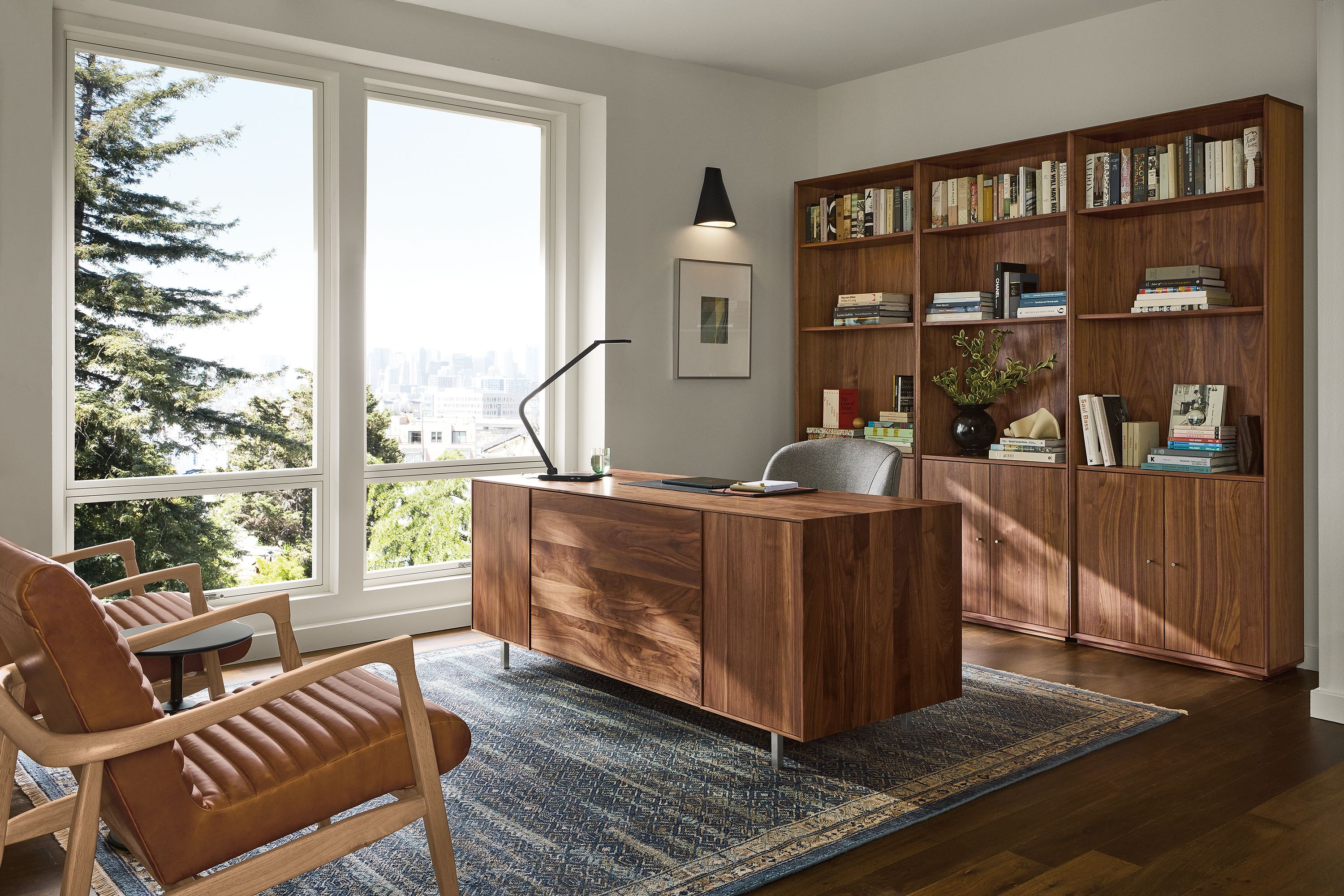 Office with Hudson double file drawer desk and 3 Rollins bookcases all in walnut and 2 Callan chairs in Sarto Cognac leather.