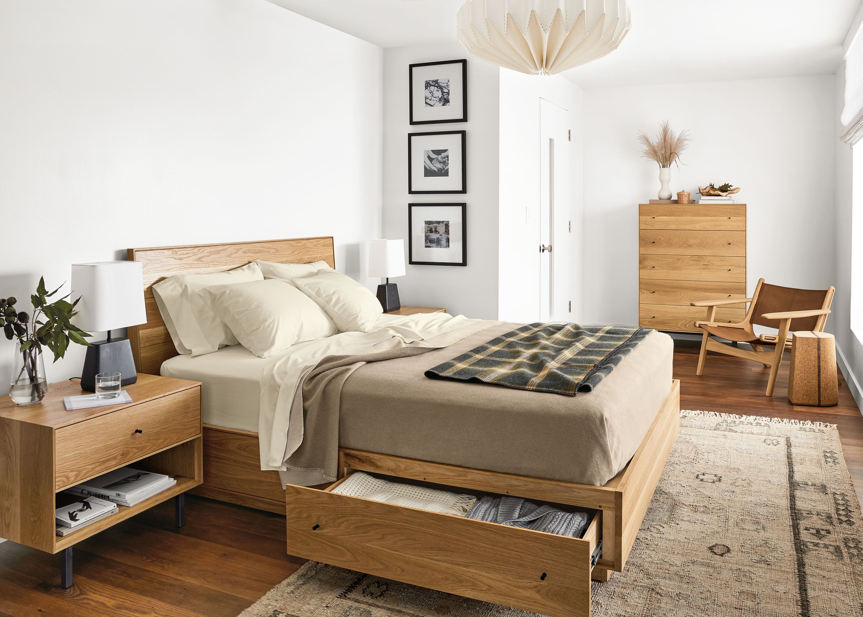 Detail of Hudson queen storage bed in white oak in bedroom with drawer open.