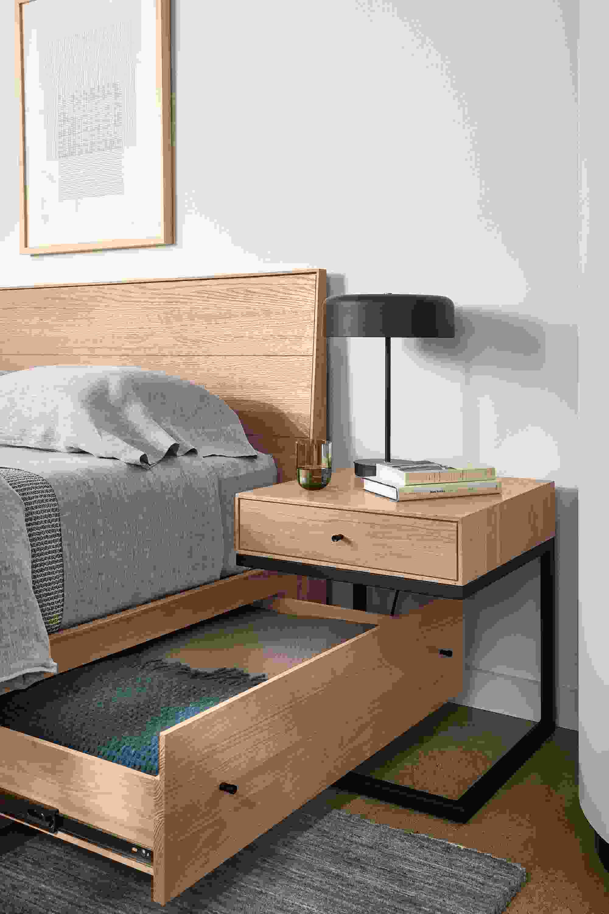 Bedroom showing open drawer on Hudson queen storage bed and Hudson one-drawer C-table in rye on red oak.