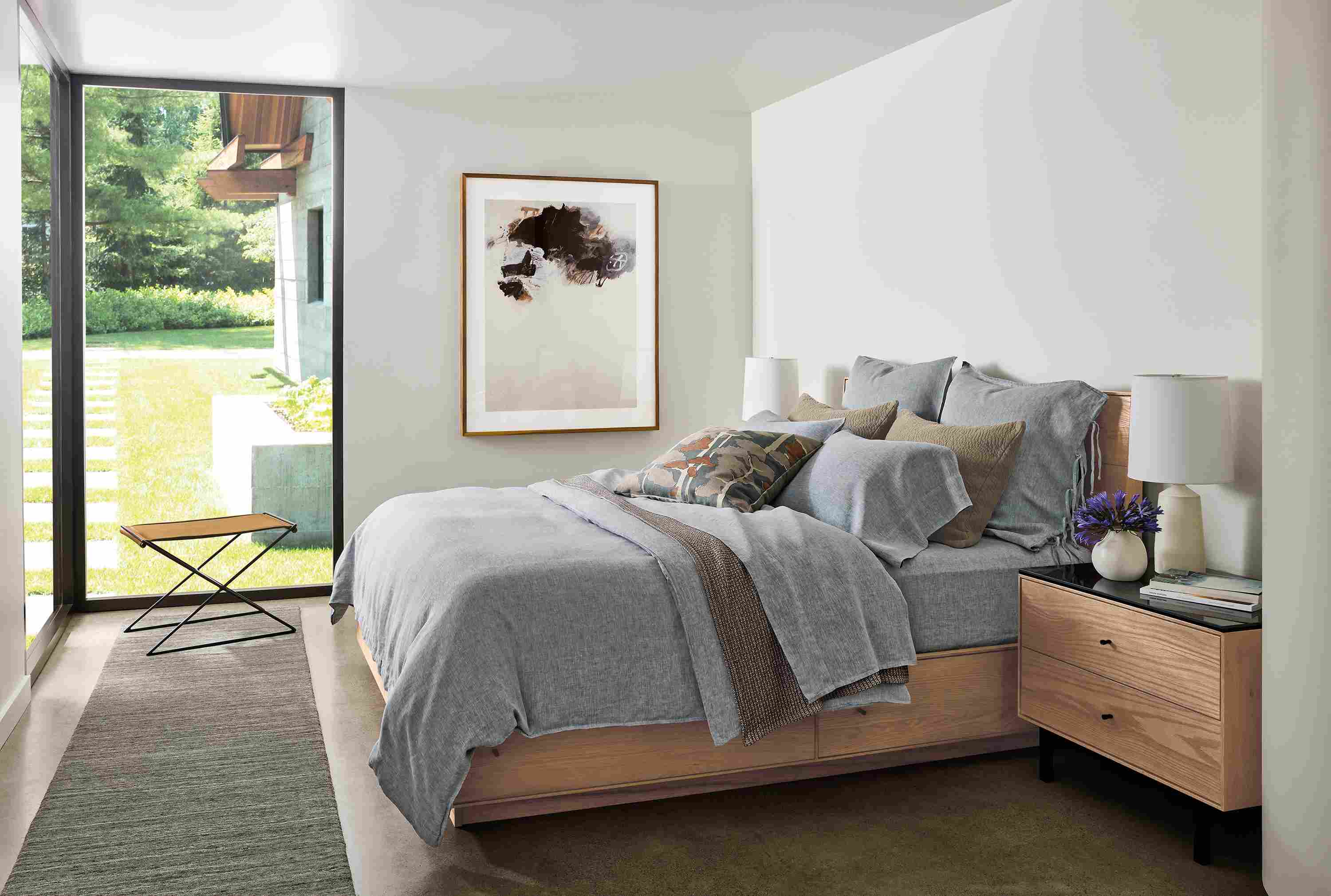 Bedroom with Hudson Queen storage bed and Hudson 2-drawer in rye on red oak and Nomad rug in charcoal.