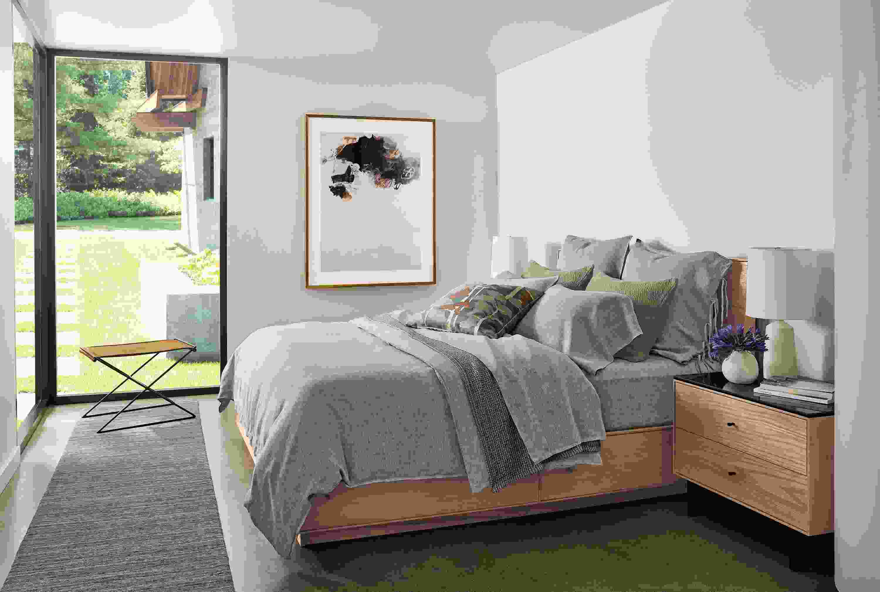 Bedroom with Hudson Queen storage bed and Hudson 2-drawer in rye on red oak and Nomad rug in charcoal.