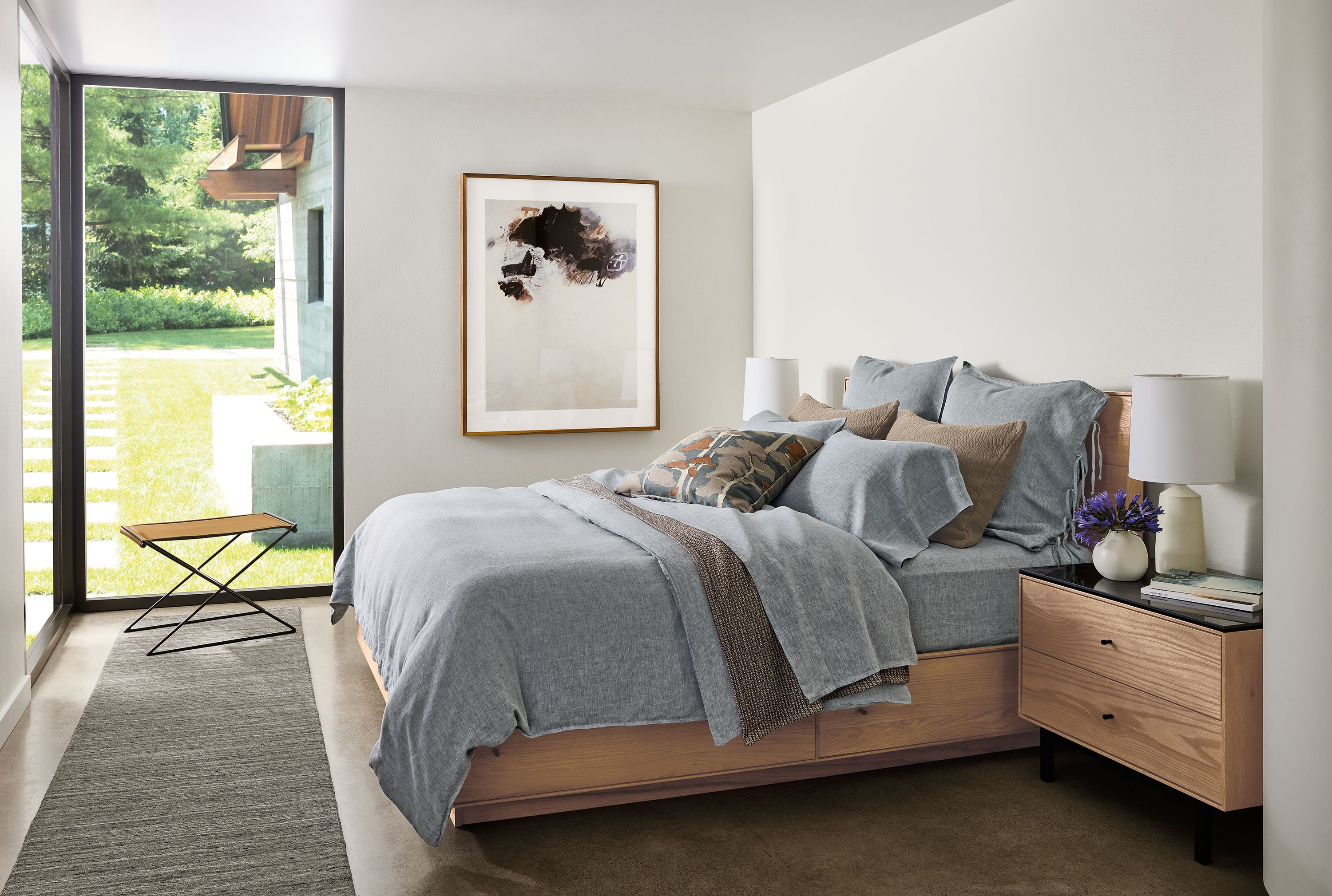 Bedroom with Hudson Queen storage bed and Hudson 2-drawer in rye on red oak and Nomad rug in charcoal.