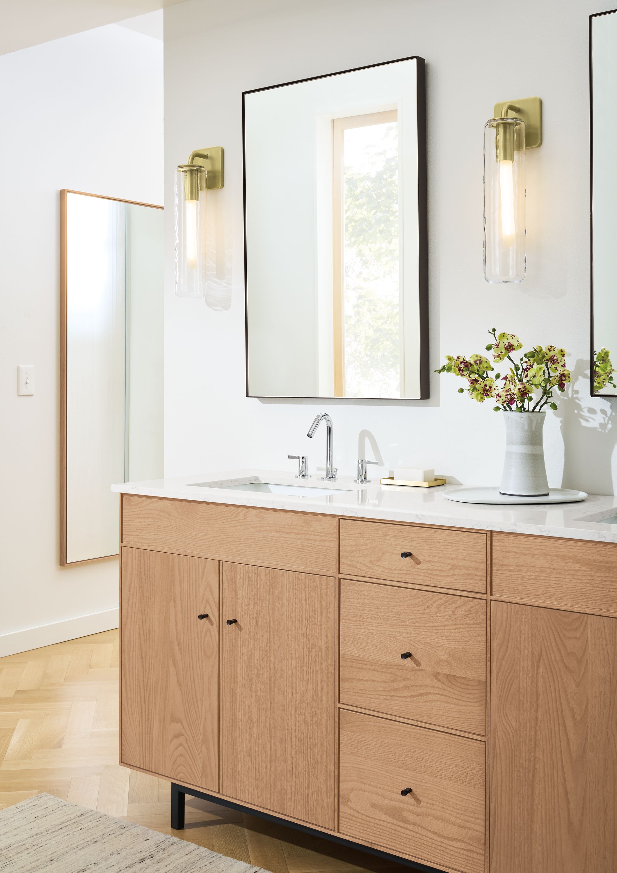 Bathroom with Hudson 72-wide double-sink bath vanity in Rye on Red Oak with Marbled White Quartz top and 2 Infinity mirrors in graphite.