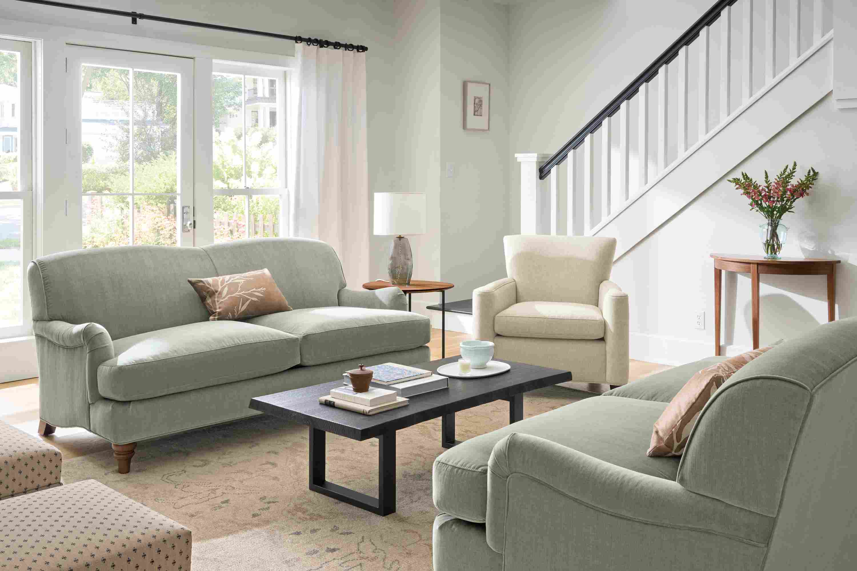 Living room with 2 Humphrey sofas in Windsor Sage and Savoy chair in Sumner Flax.