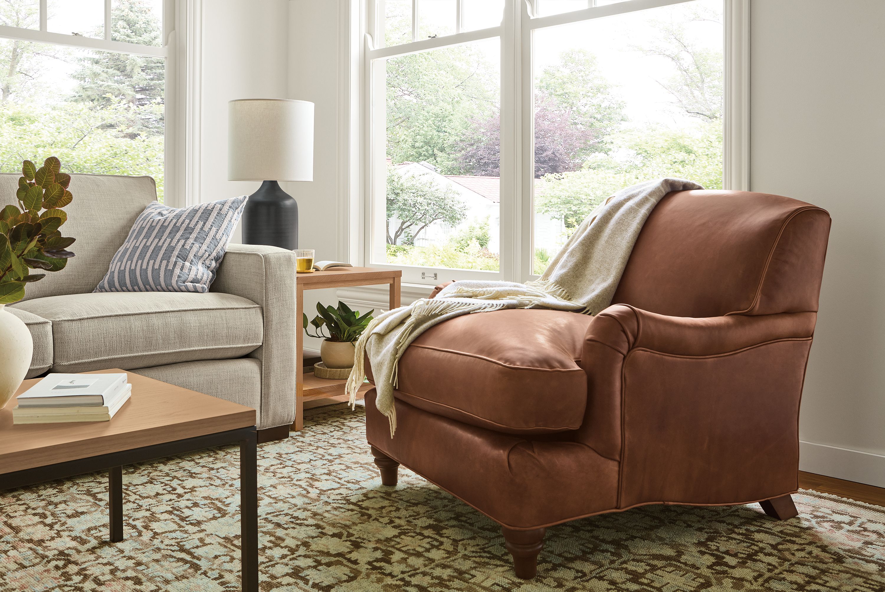 Living room with Humphrey chair in Sarto Cognac leather and Morrison 96-wide sofa in Olmstead Natural.