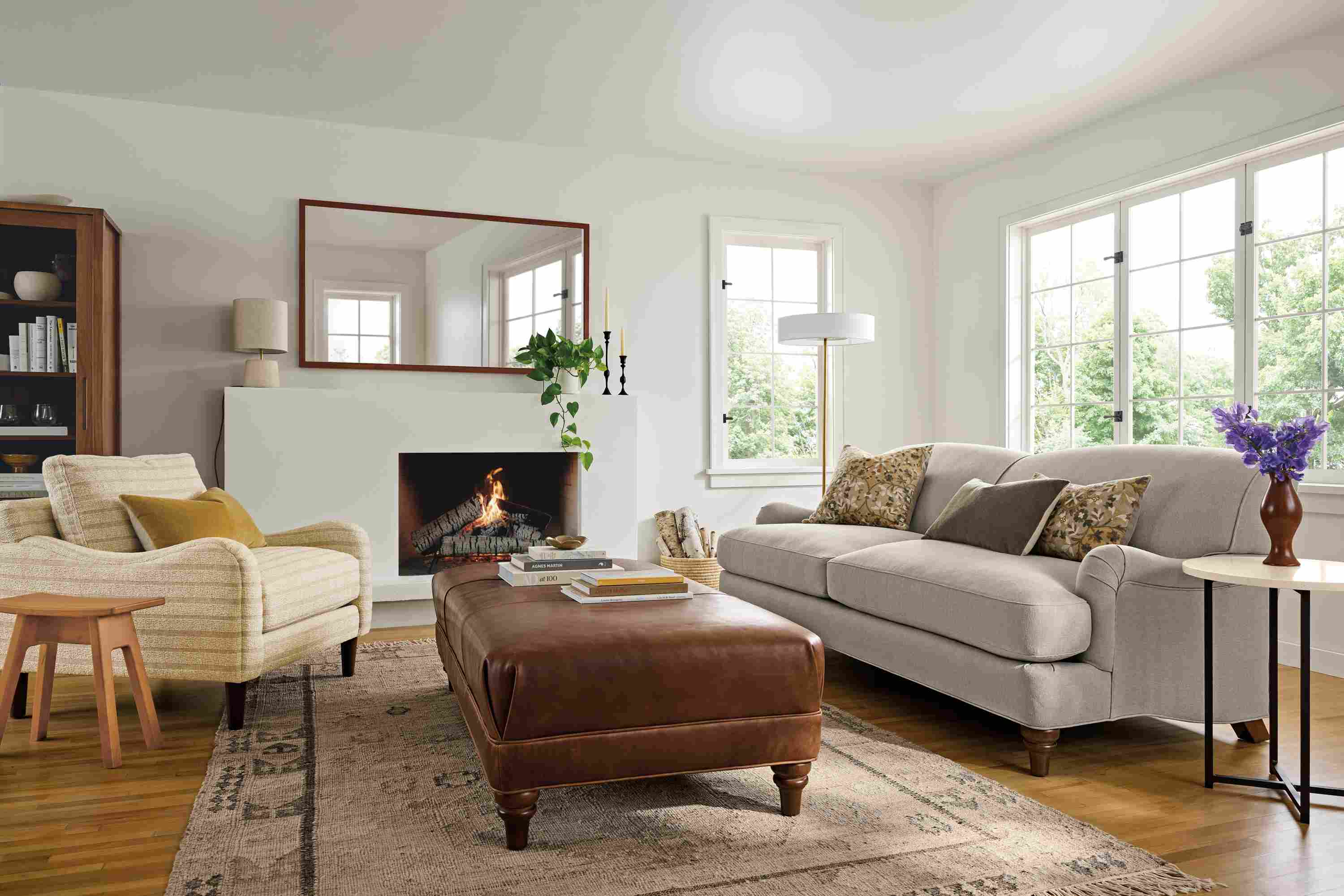 Living room with Humphrey sofa in Landen Asphalt, Eloise chair in Auckland Natural and Humphrey ottoman in Sarto Cognac.