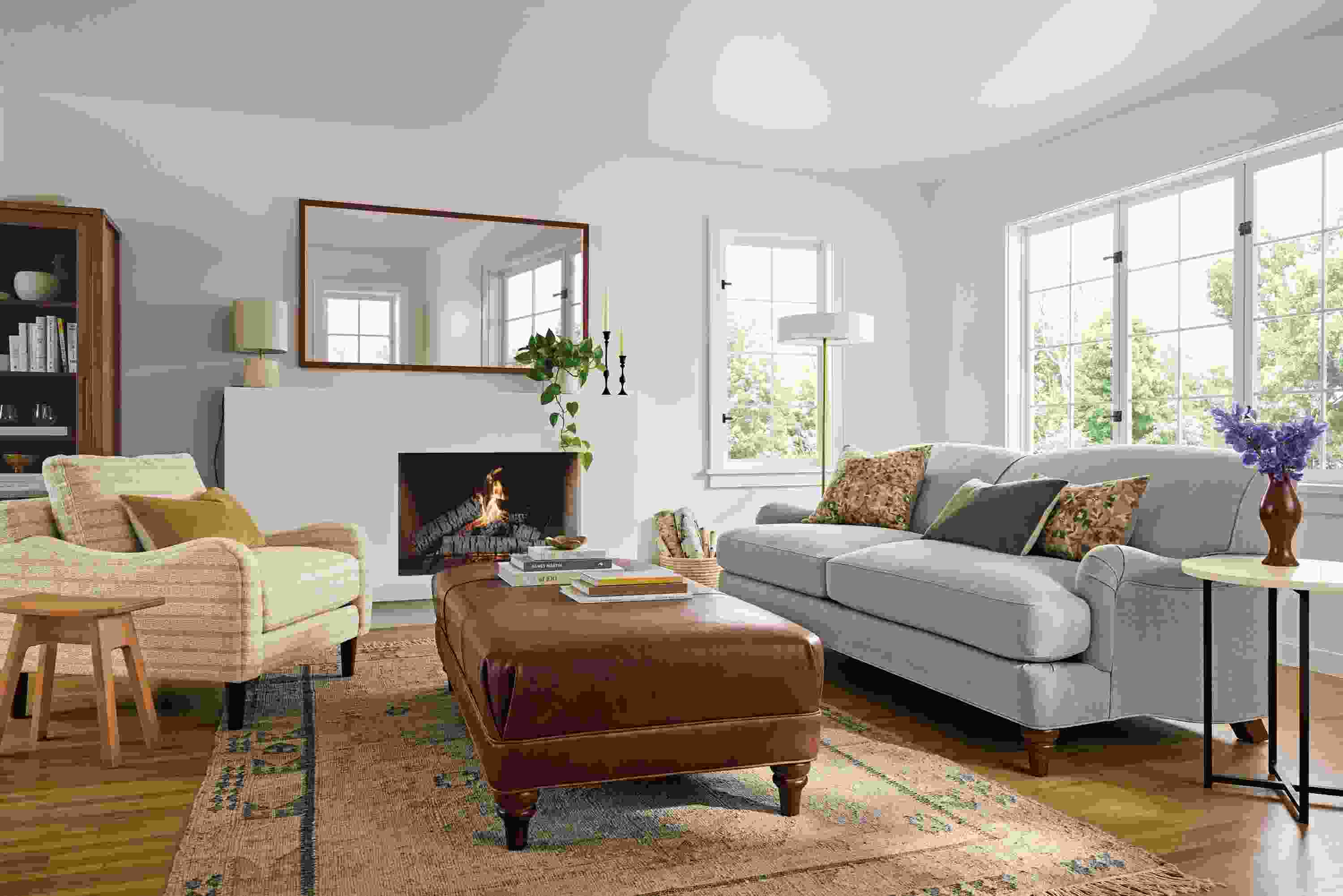 Living room with Humphrey sofa in Landen Asphalt, Eloise chair in Auckland Natural and Humphrey ottoman in Sarto Cognac.