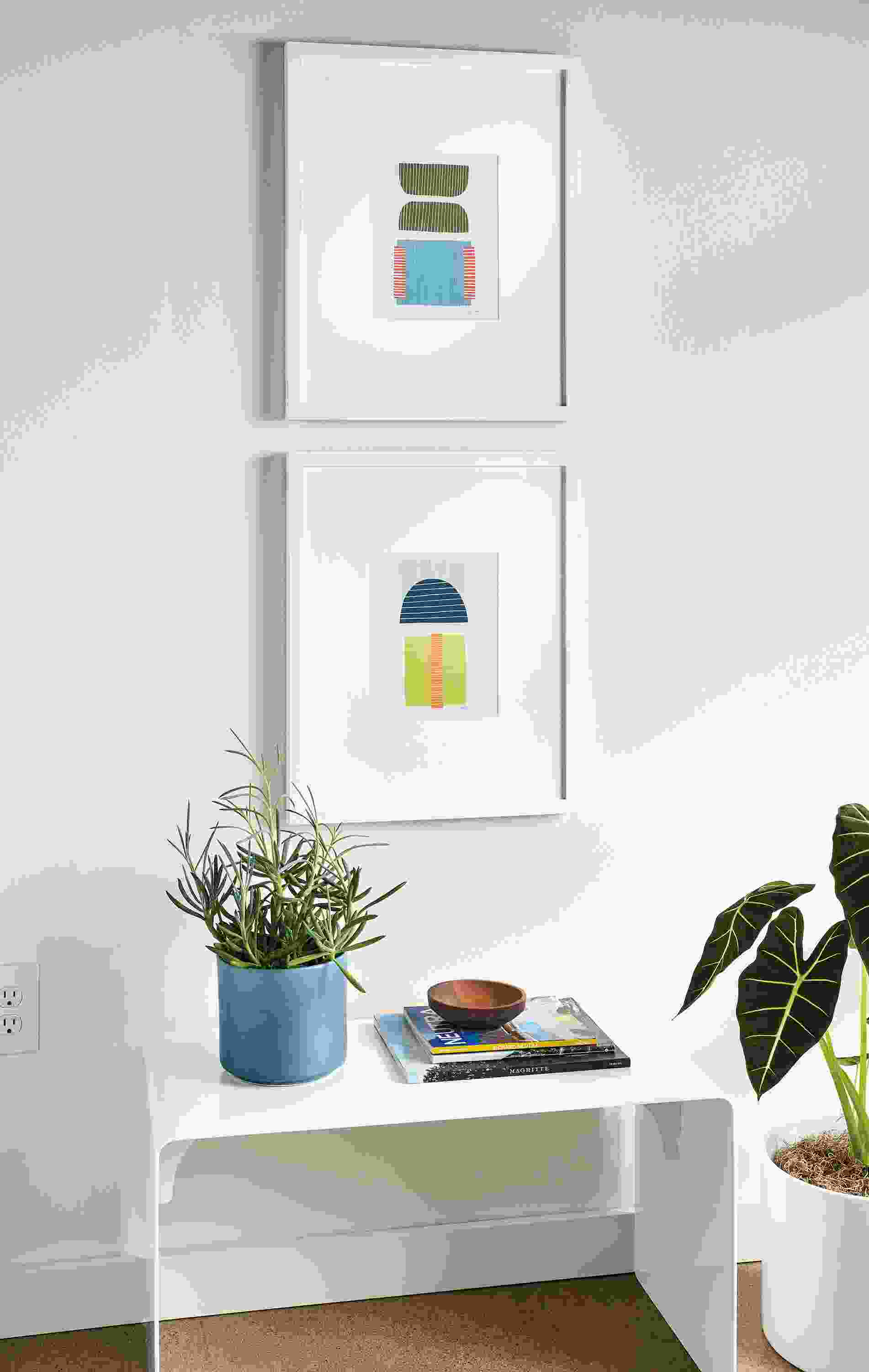 Close-up of Jorey Hurley art pieces Colorful shapes abstract 2and 1 and Cooper Bench in white.