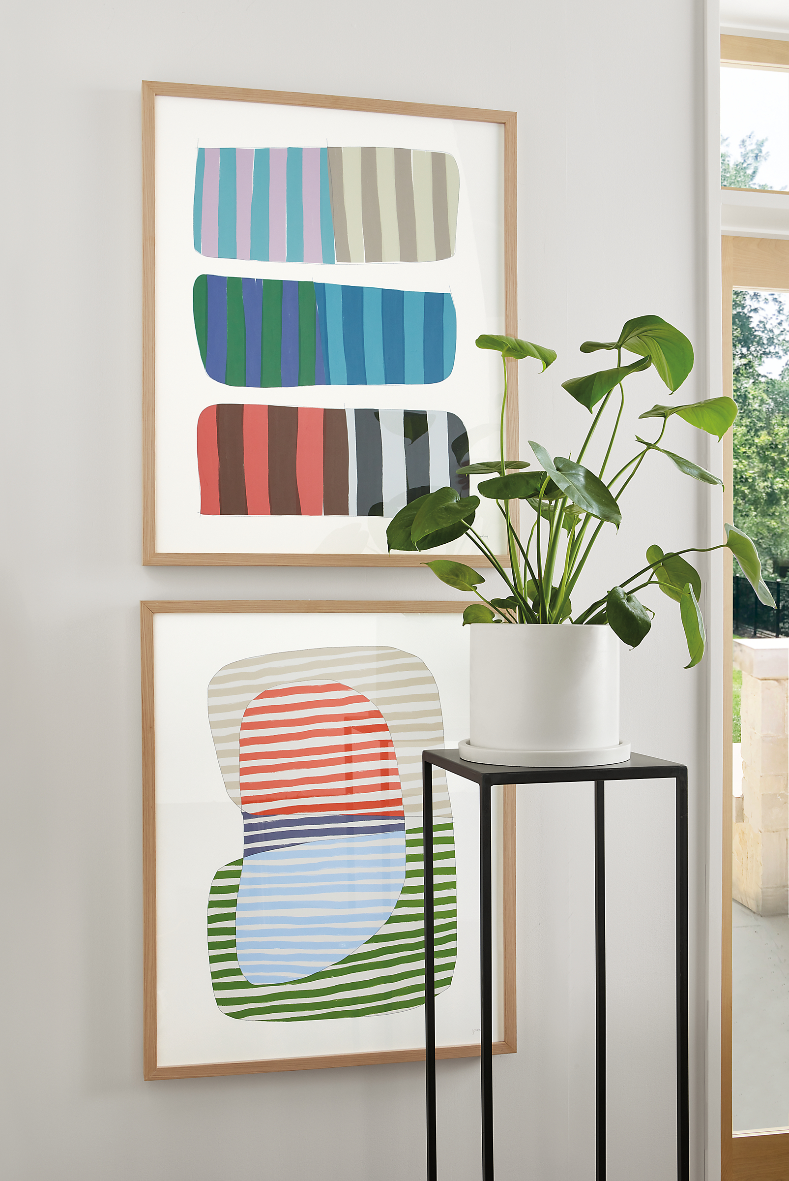 Close-up of Jorey Hurley artwork, Abstrac Stripes 1 and 2 with white oak frame and slim table in natural steel.