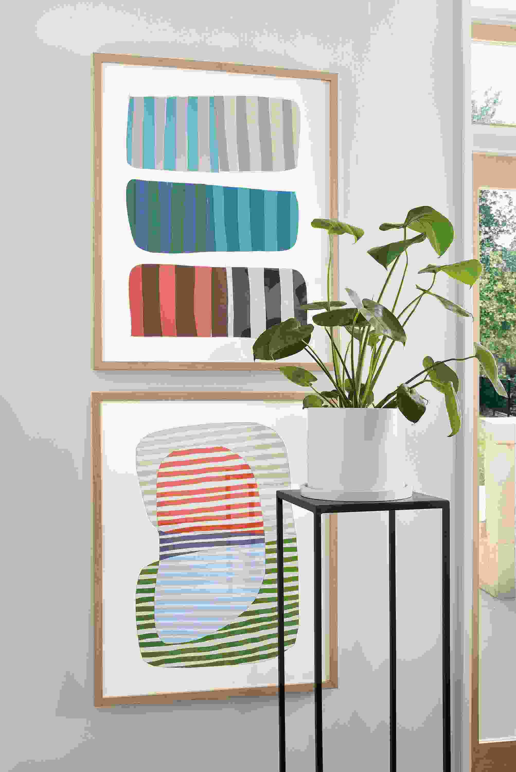 Close-up of Jorey Hurley artwork, Abstrac Stripes 1 and 2 with white oak frame and slim table in natural steel.