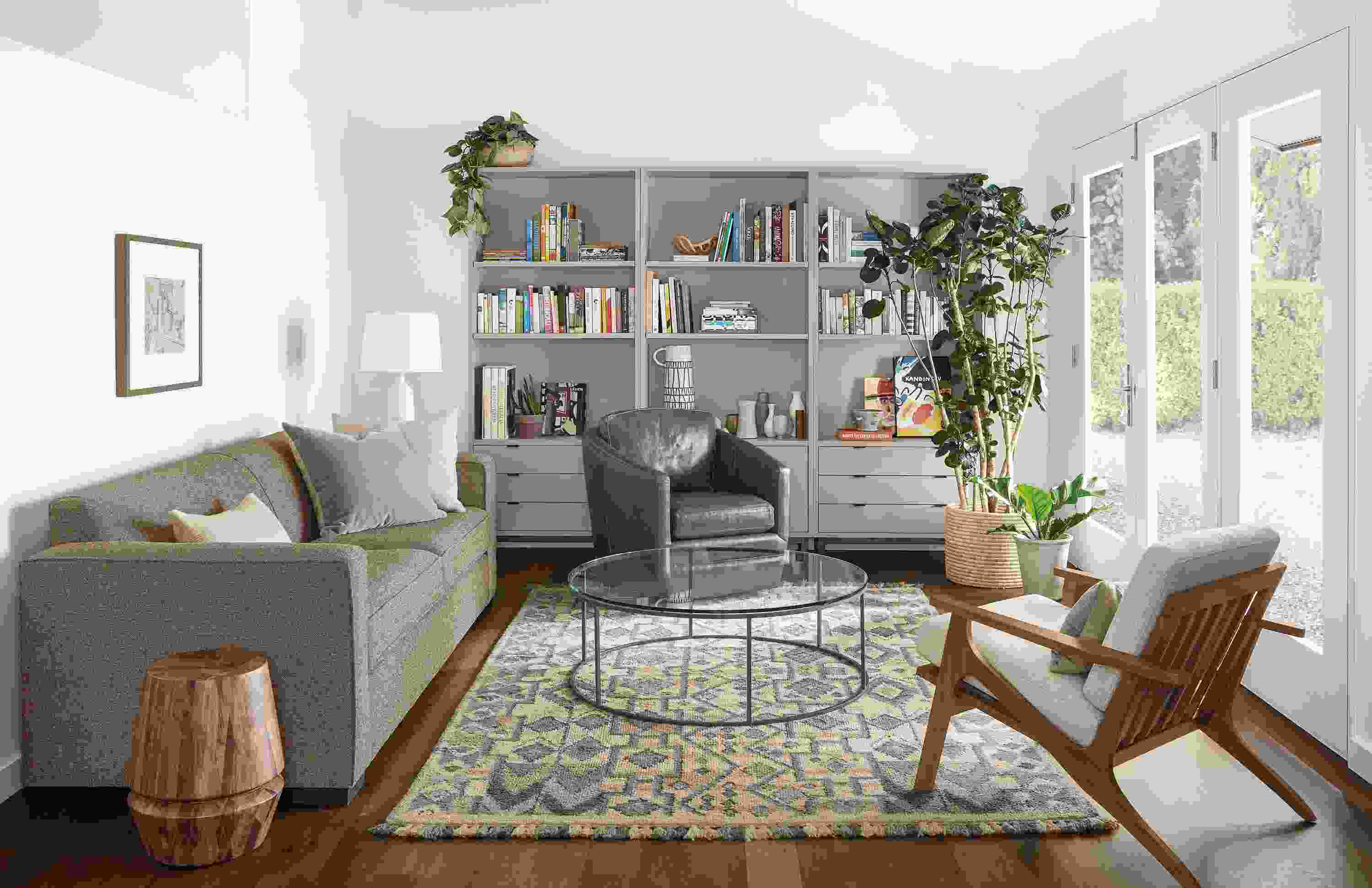 Living room with Ian sofa in Tatum Mink, Ford swivel chair in Vento ink and Ona rug in ocean.