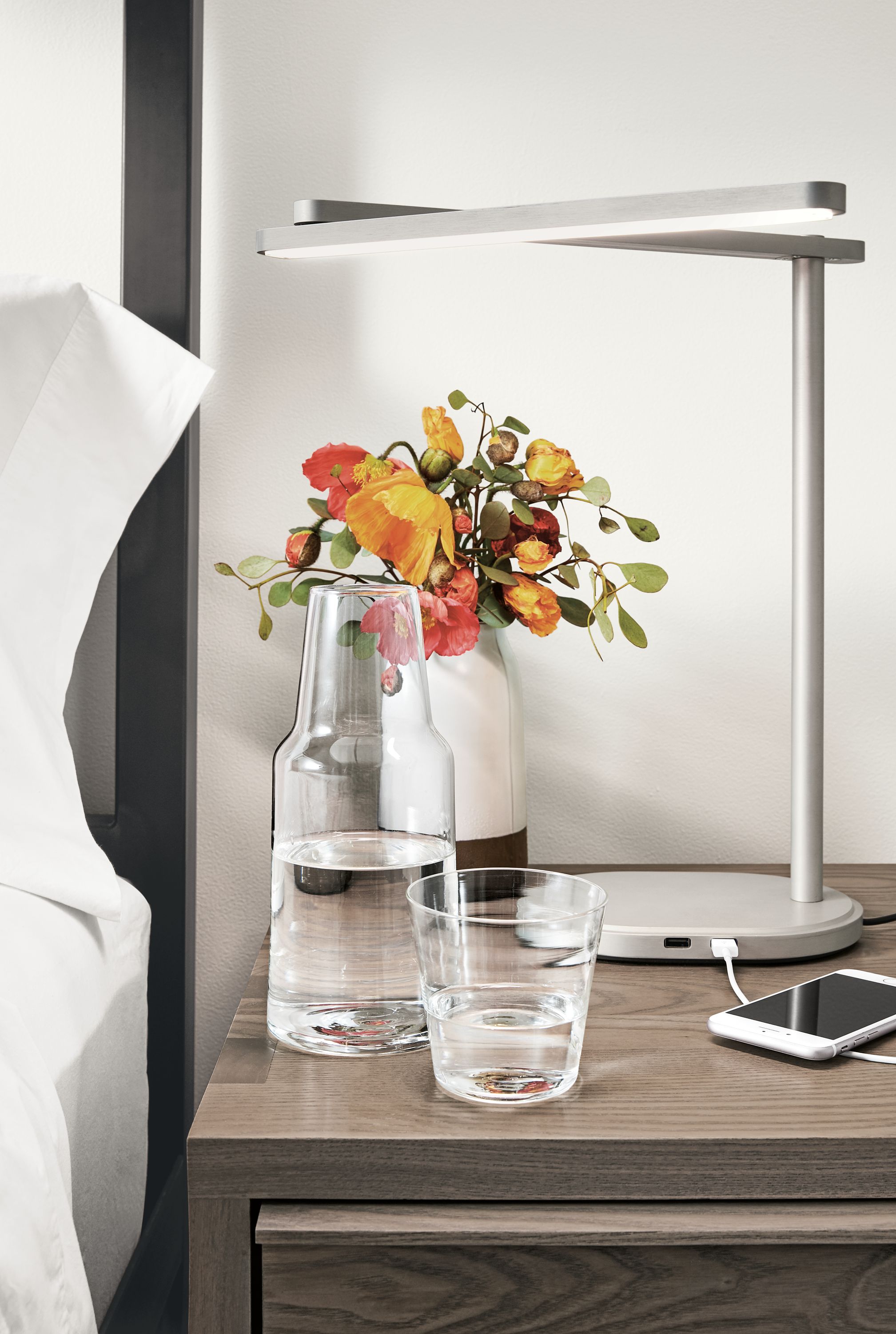 Detail of Ina carafe in clear glass on nightstand.