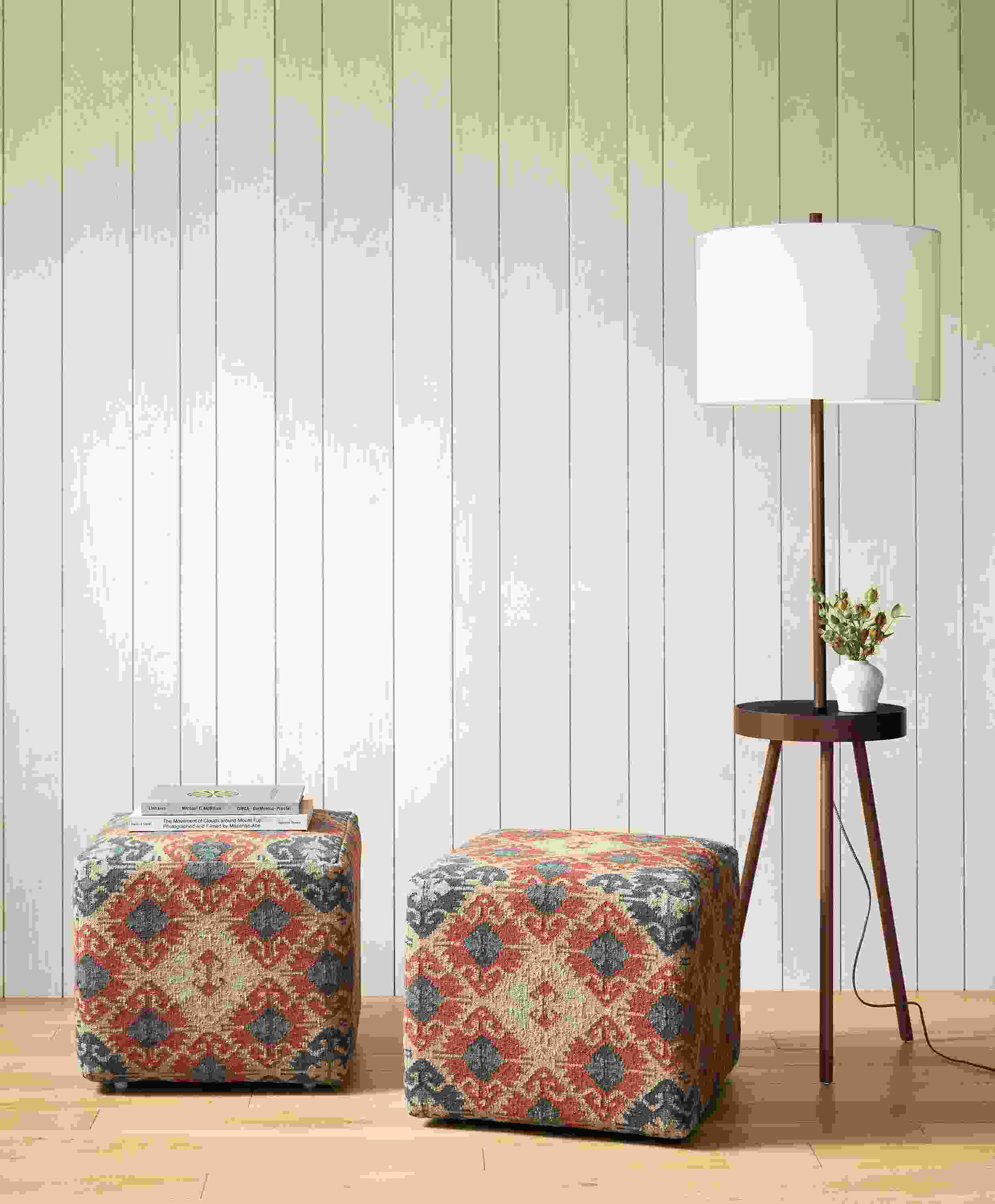 Detail of 2 Indira square ottomans in Paprika beside Winford floor lamp.