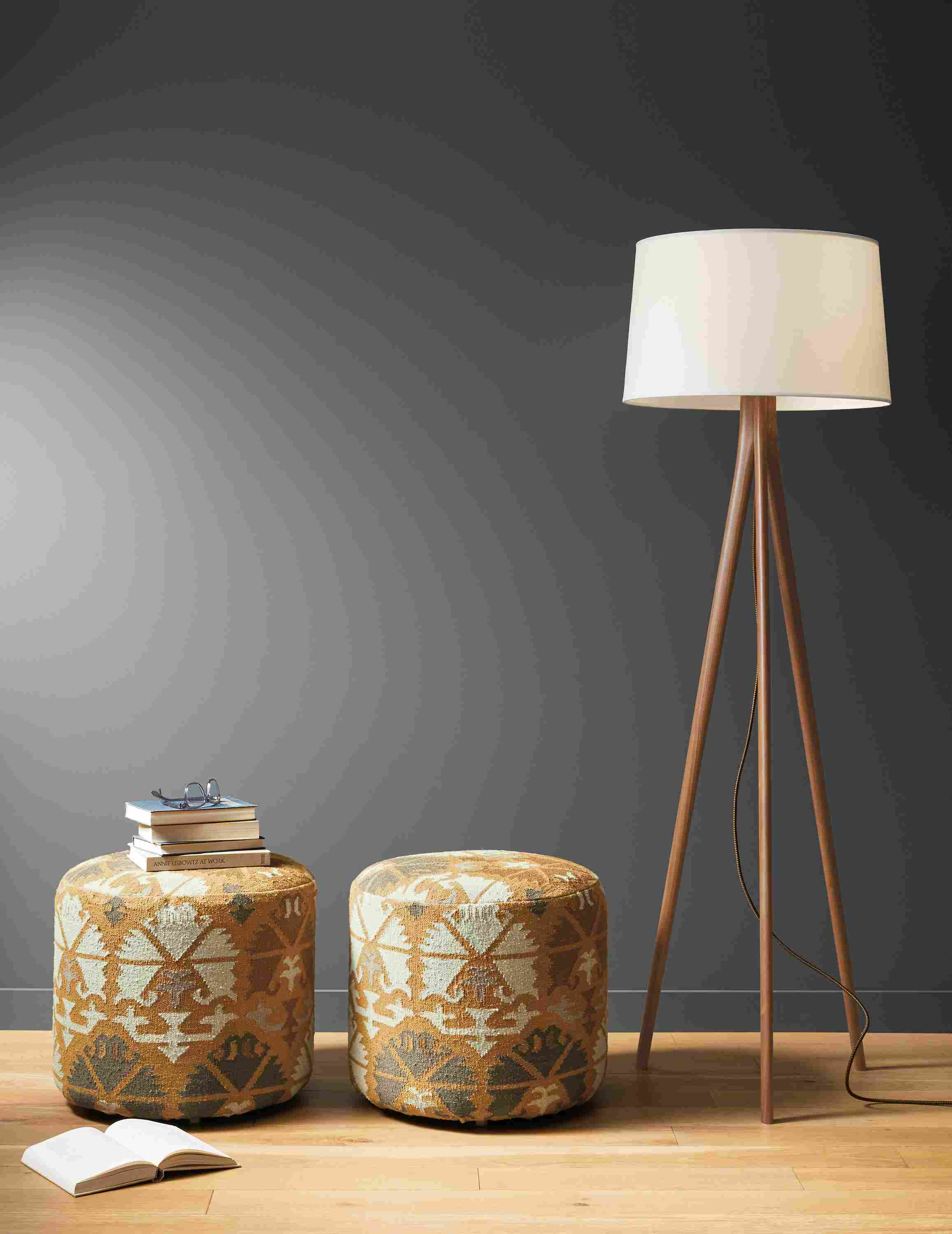 Detail of 2 Indira round ottomans in Saffron beside Lane floor lamp.