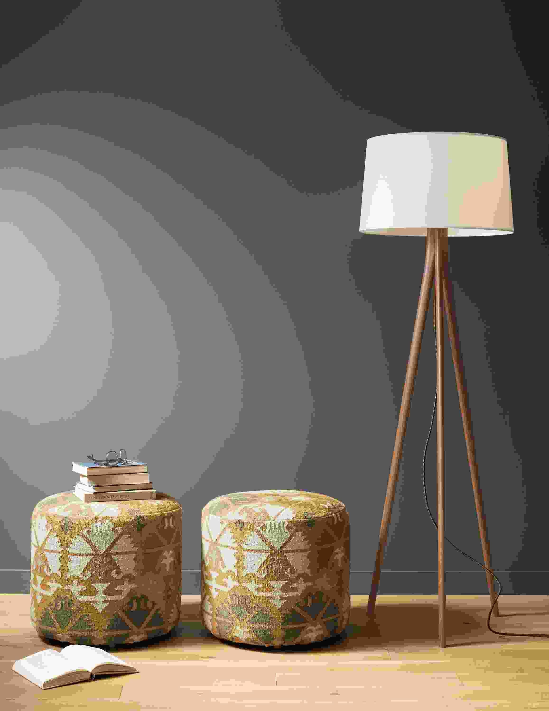 Detail of 2 Indira round ottomans in Saffron beside Lane floor lamp.