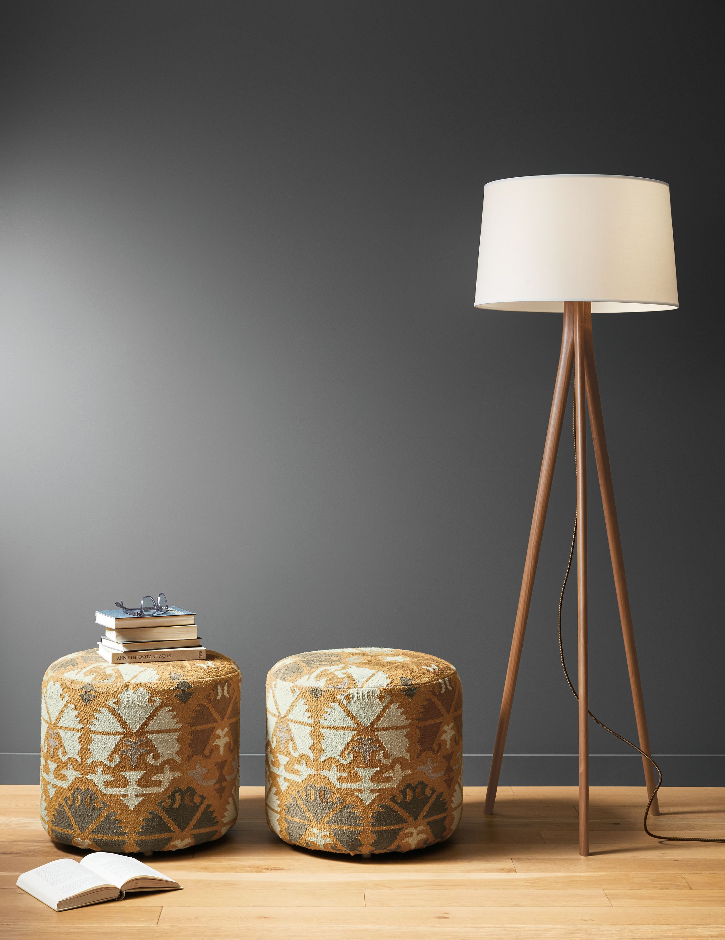Detail of 2 Indira round ottomans in Saffron beside Lane floor lamp.
