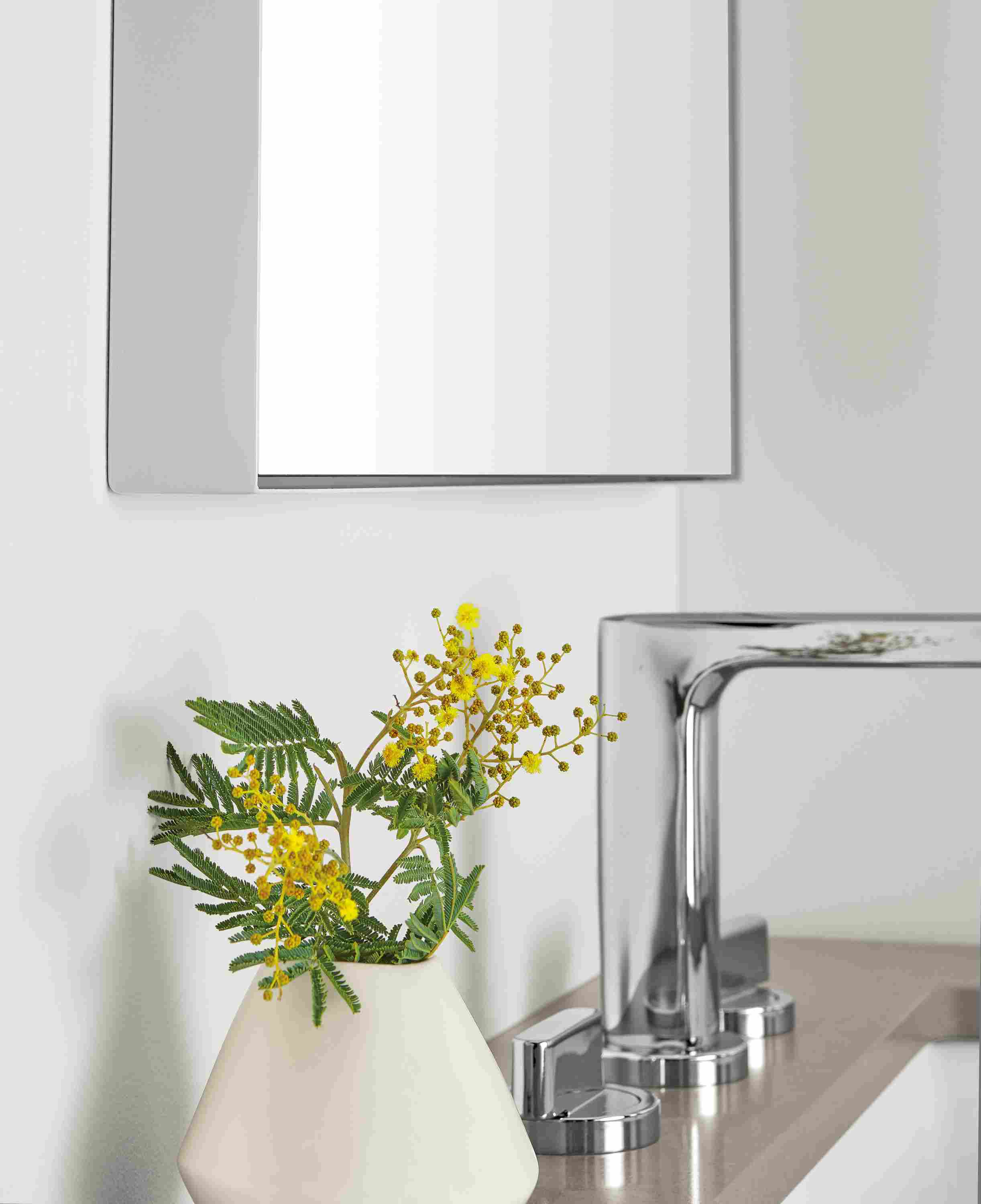 Detail showing the corner and width of an Infinity mirror in light grey above a Kenwood vanity.
