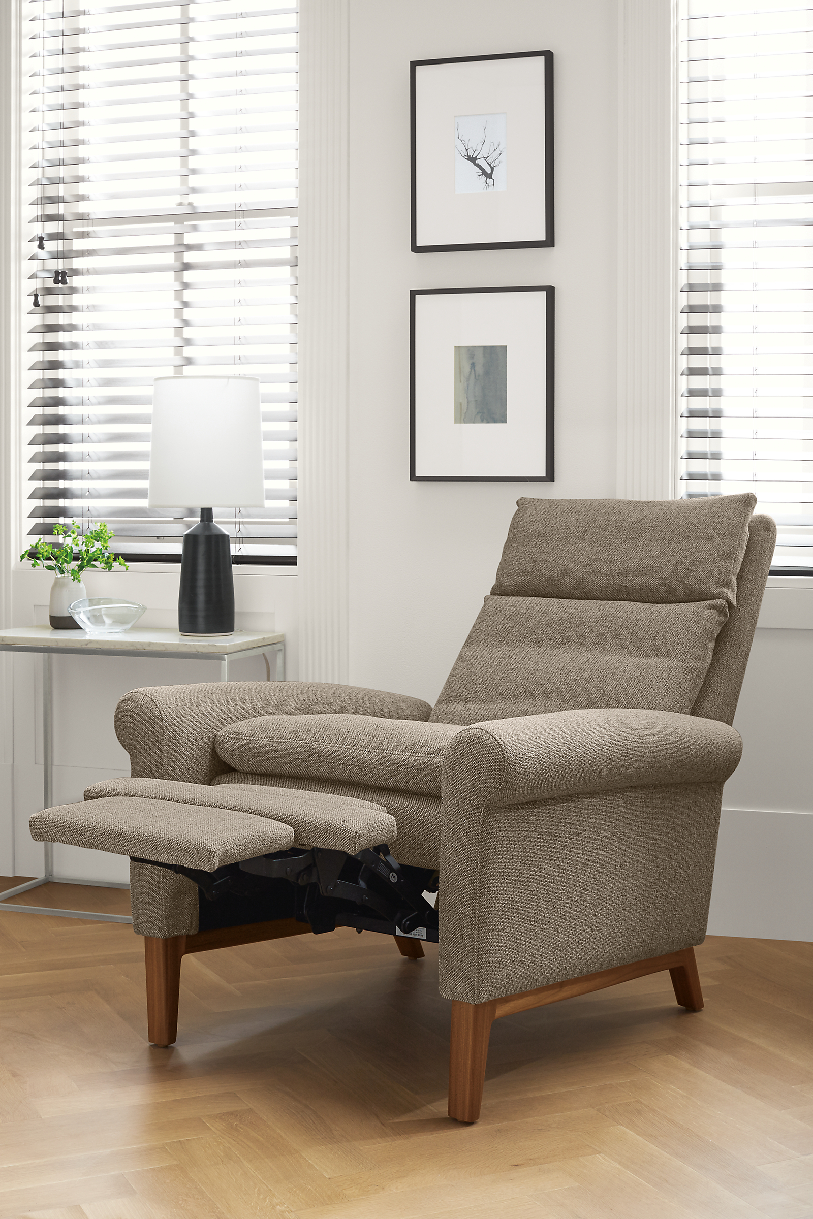 Detail of Isaac rolled-arm recliner with wood base and foot rest extended.