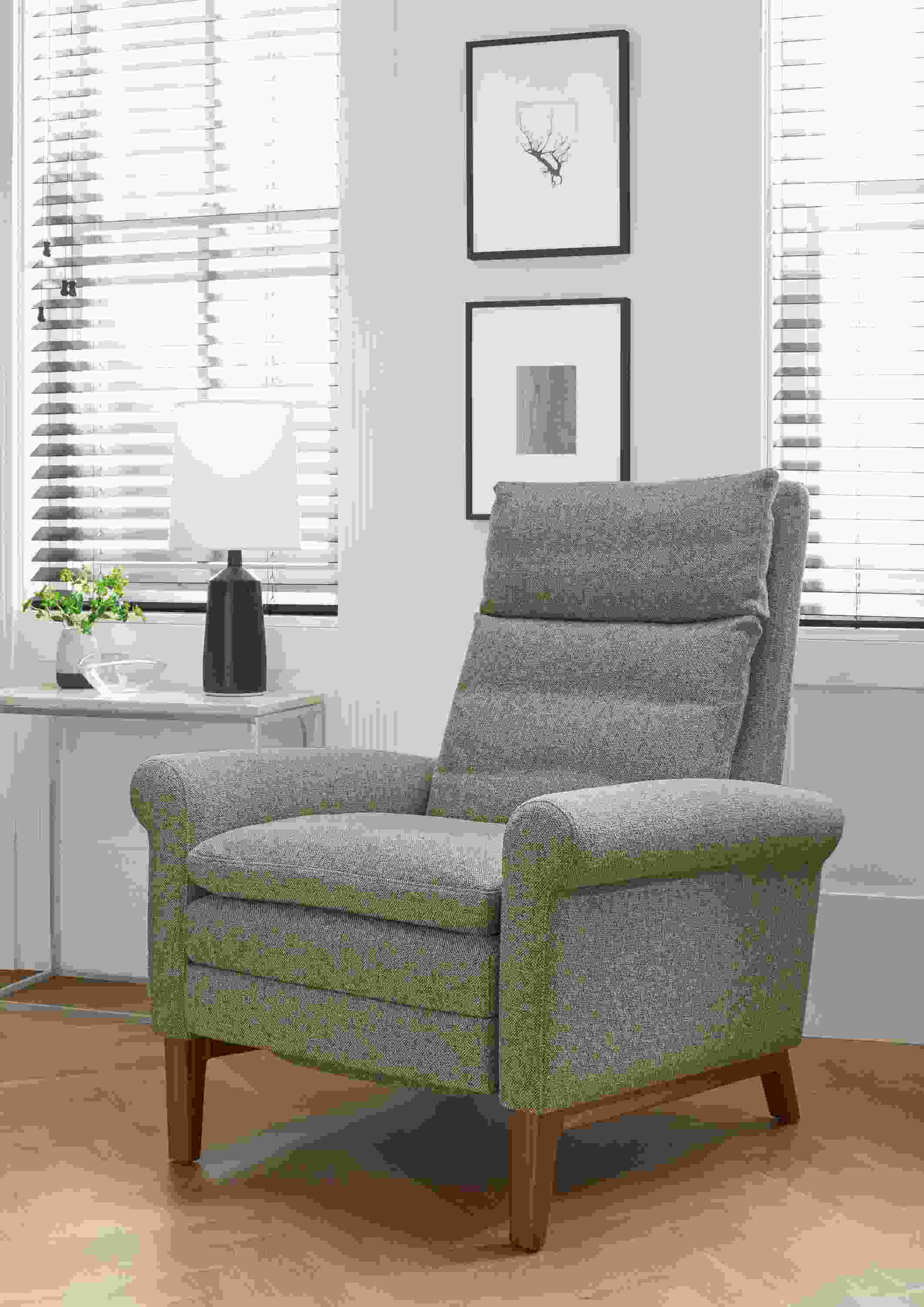 Detail of Isaac rolled-arm recliner in Tatum Grey with walnut base.