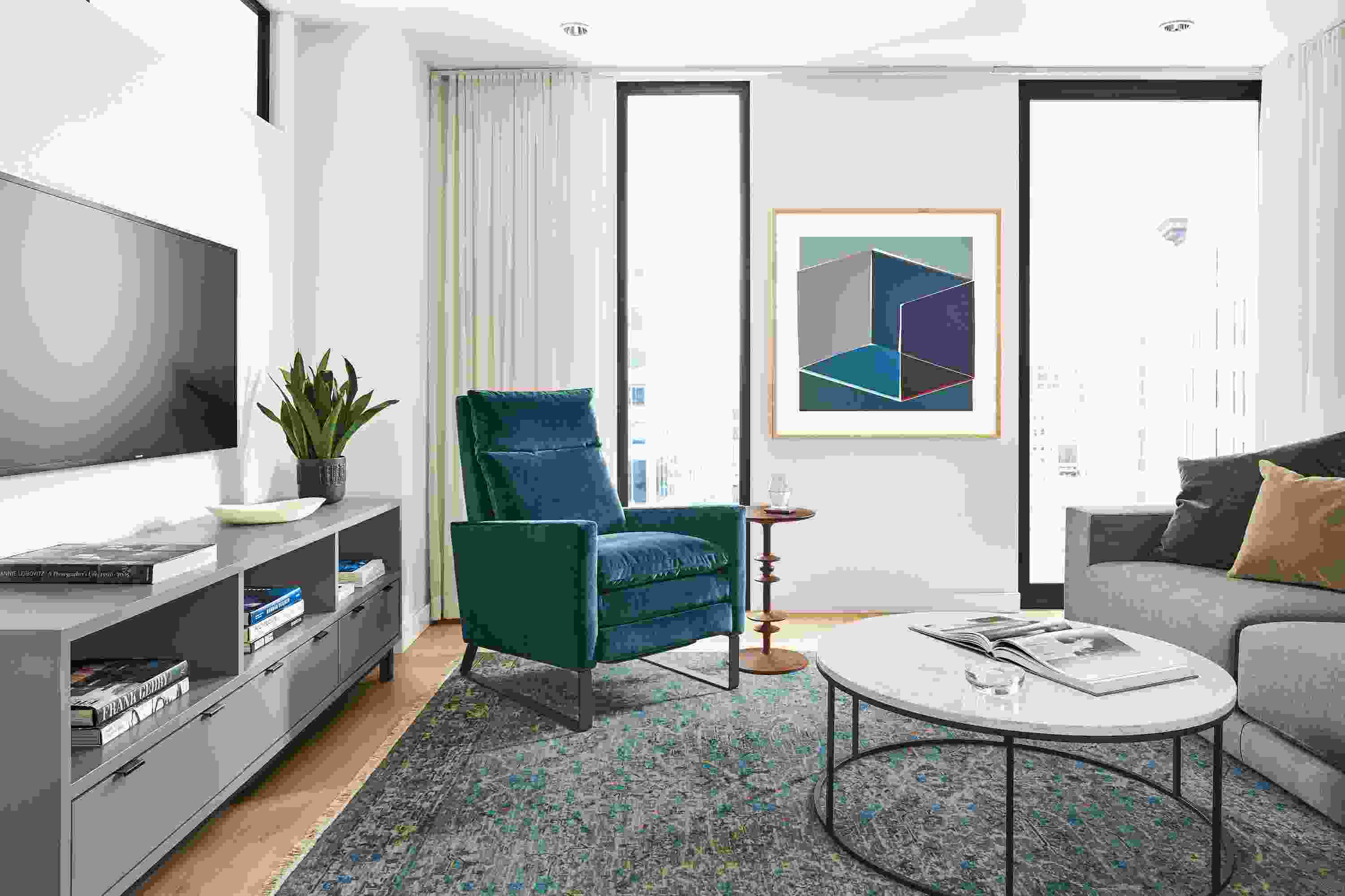 Detail of Isaac Select recliner in Banks Lagoon velvet in living room with Caspian rug in ocean.
