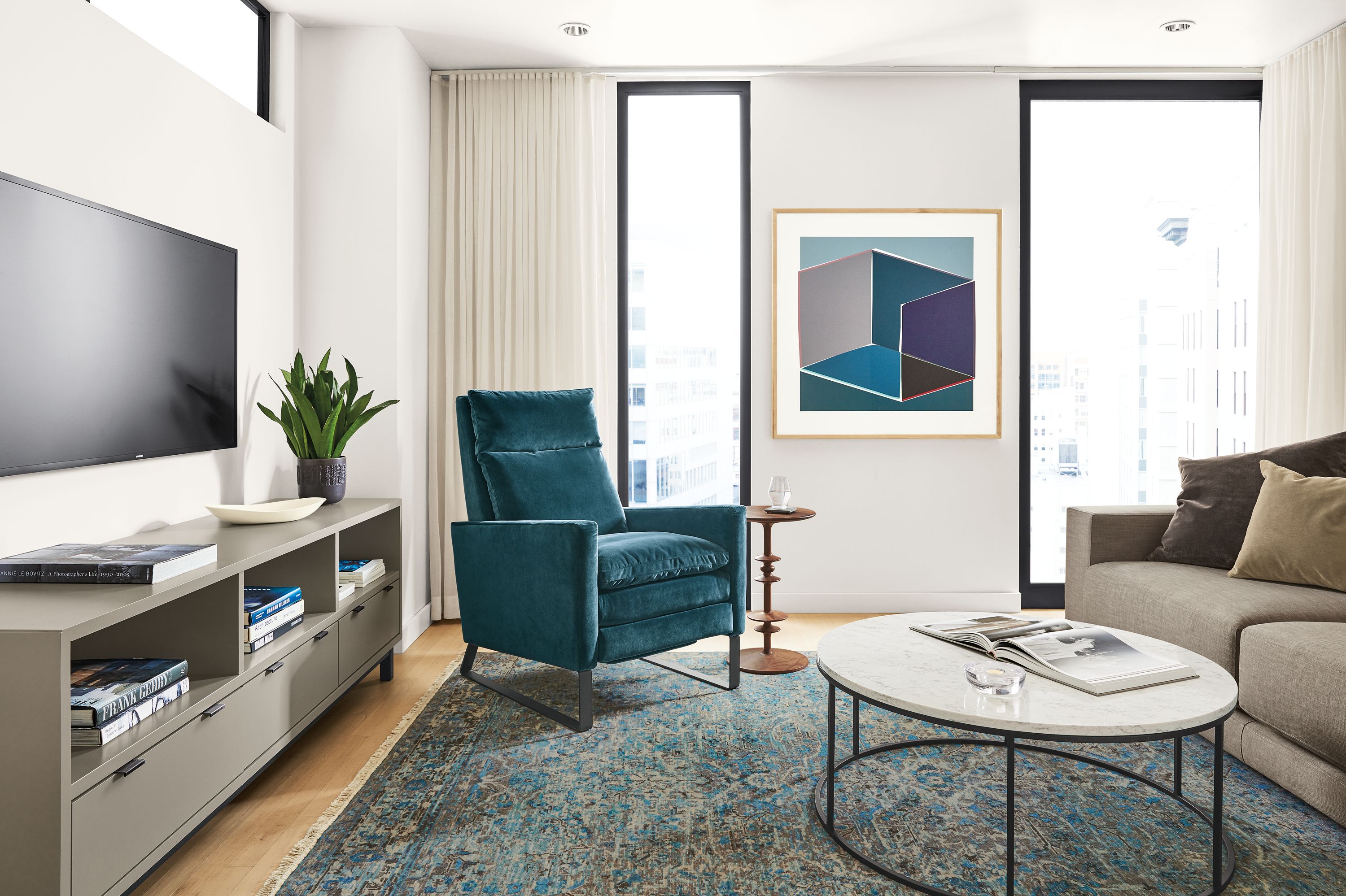 Detail of Isaac Select recliner in Banks Lagoon velvet in living room with Caspian rug.