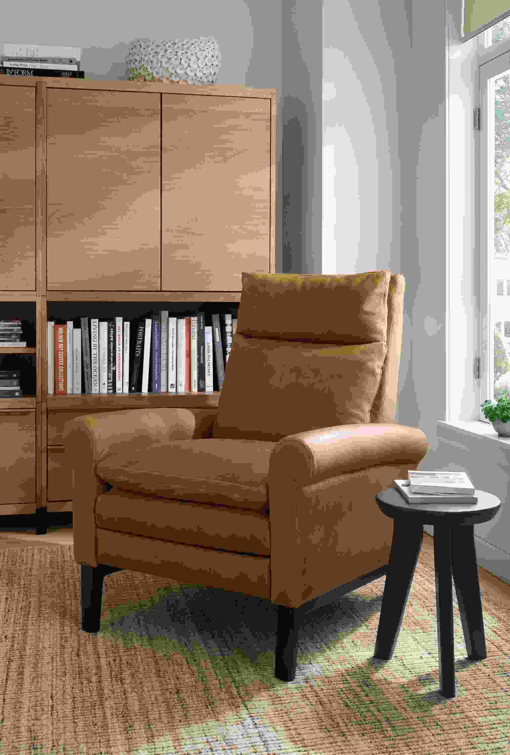 Living room with Isaac recliner in Sarto Camel, Hollins stool in charcoal reclaimed pine and Artis rug in stone.