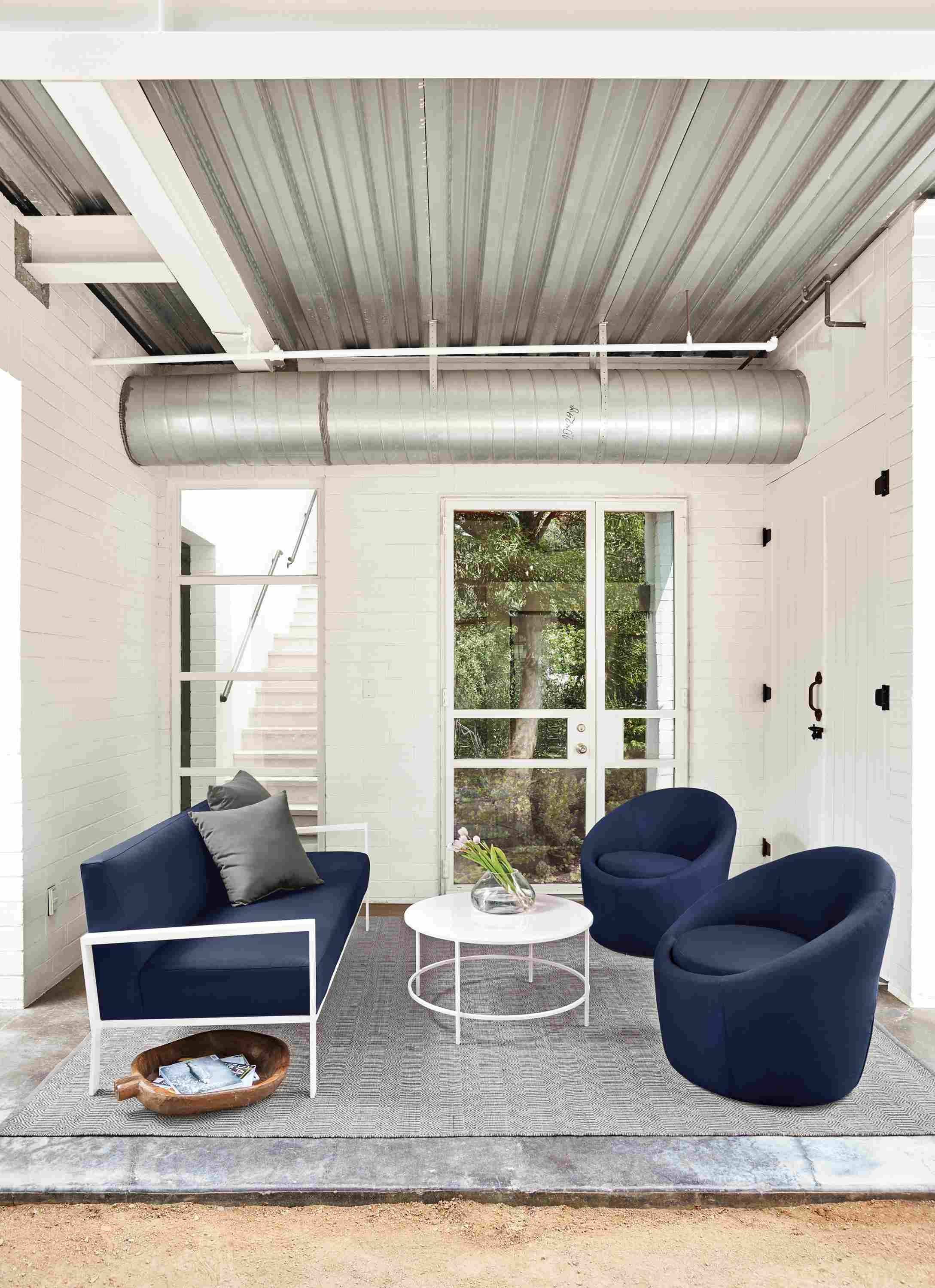 Detail of Isles outdoor sofa and 2 crest chairs all in Sunbrella Canvas Navy.