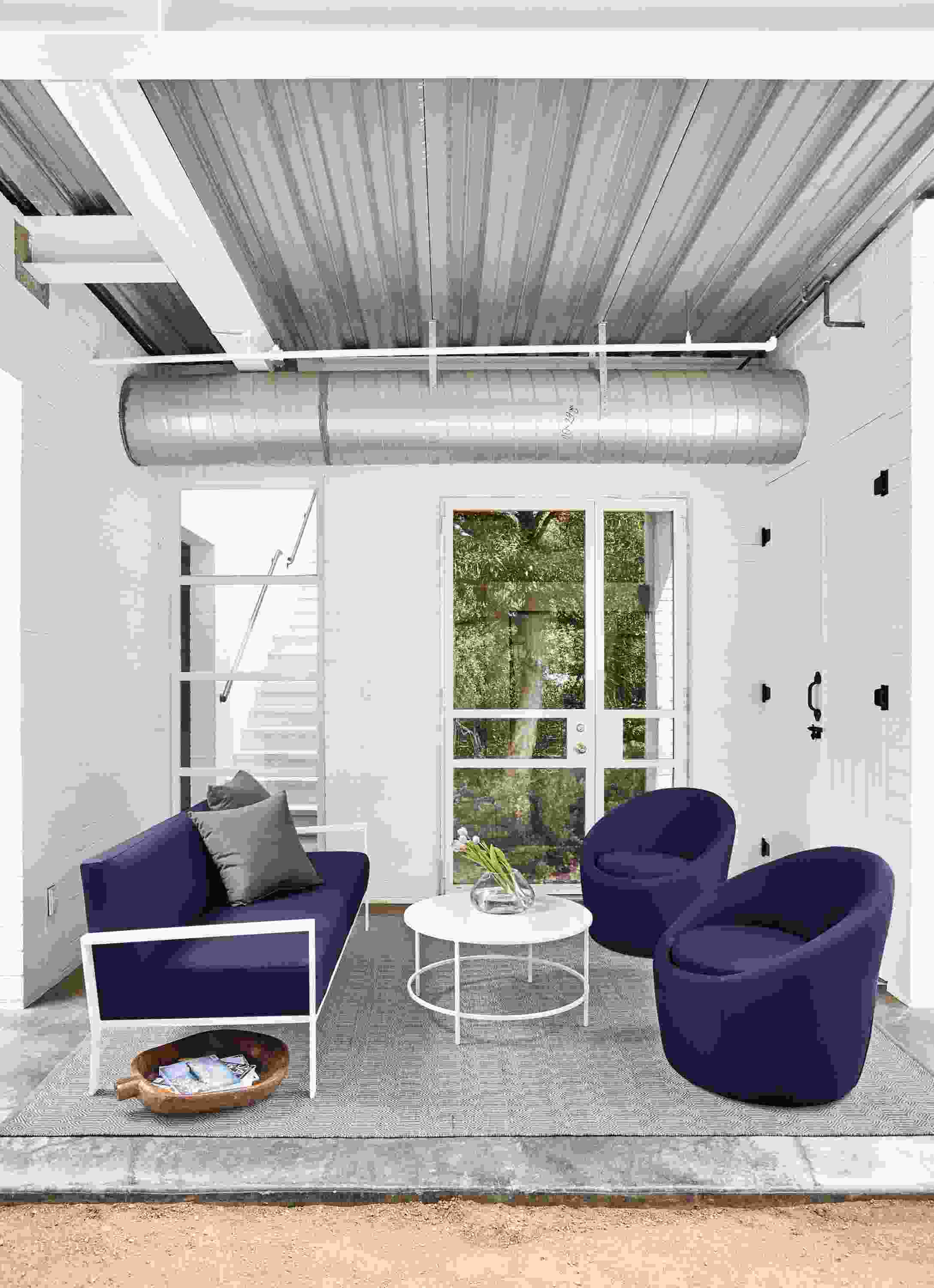 Detail of Isles outdoor sofa and 2 crest chairs all in Sunbrella Canvas Navy.