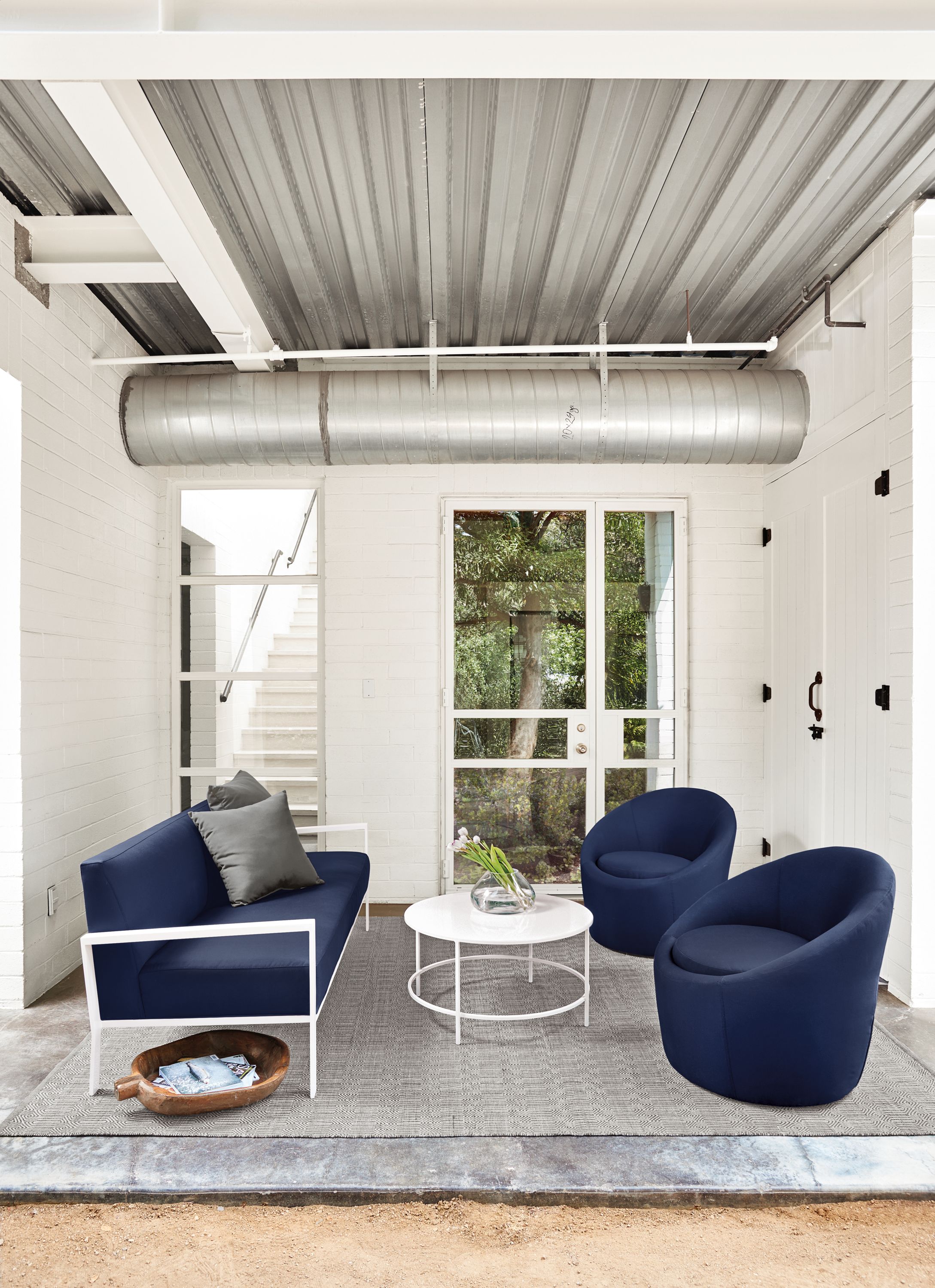Detail of Isles outdoor sofa and 2 crest chairs all in Sunbrella Canvas Navy.