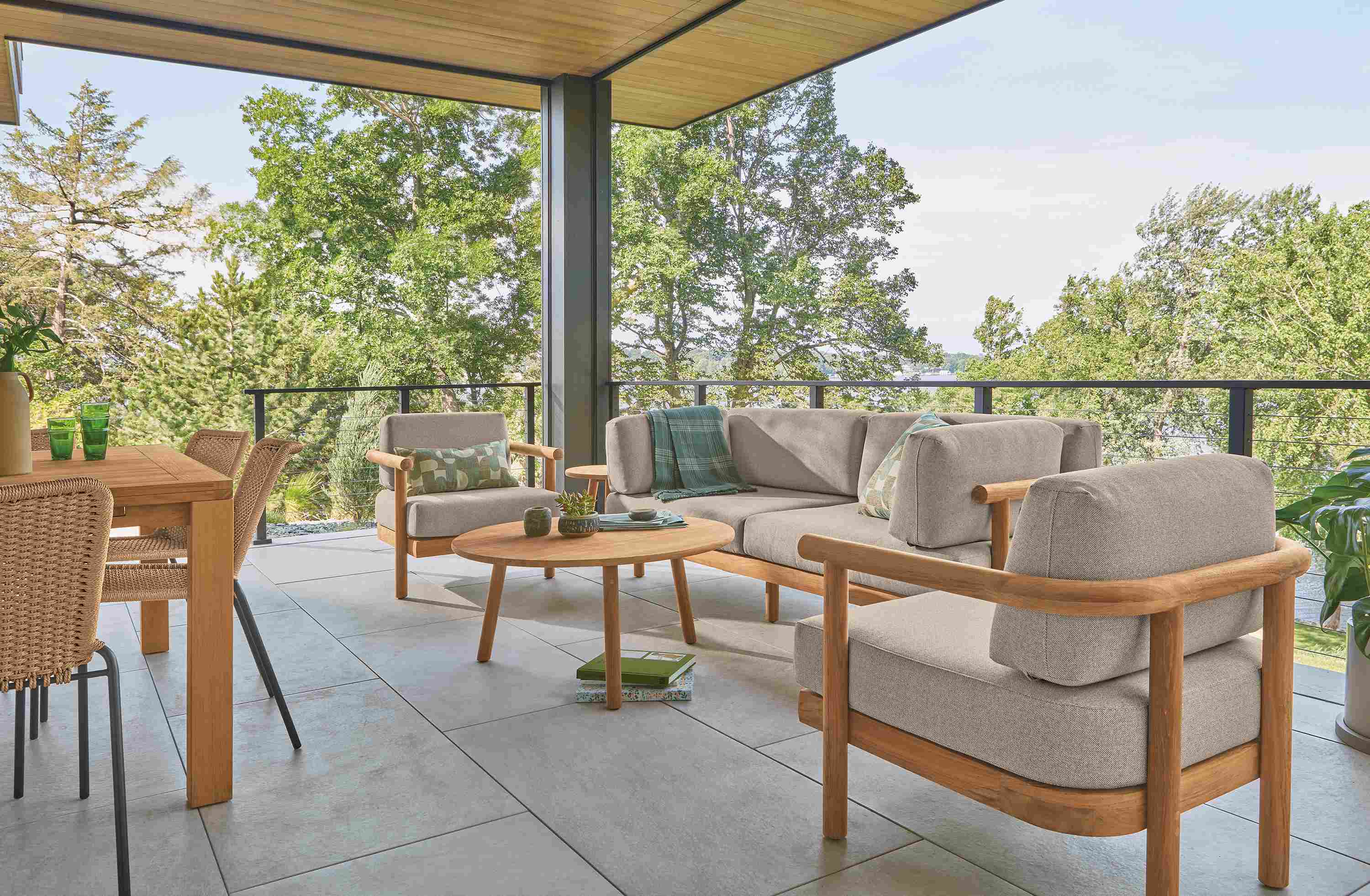 Veranda with Isley sofa, lounge chair and coffee tables in teak heartwood and Capri table in Teak Heartwood.