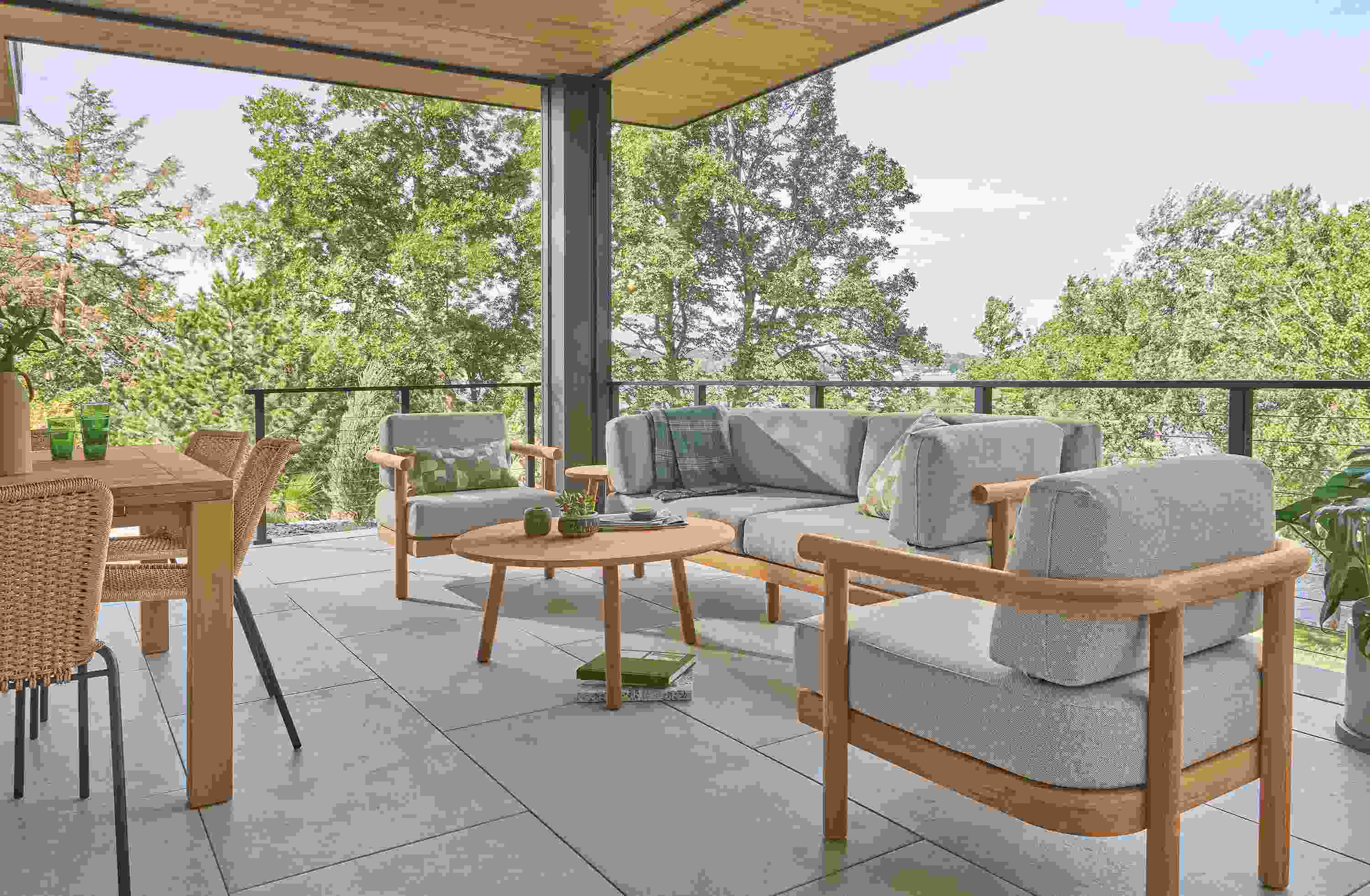 Veranda with Isley sofa, lounge chair and coffee tables in teak heartwood and Capri table in Teak Heartwood.
