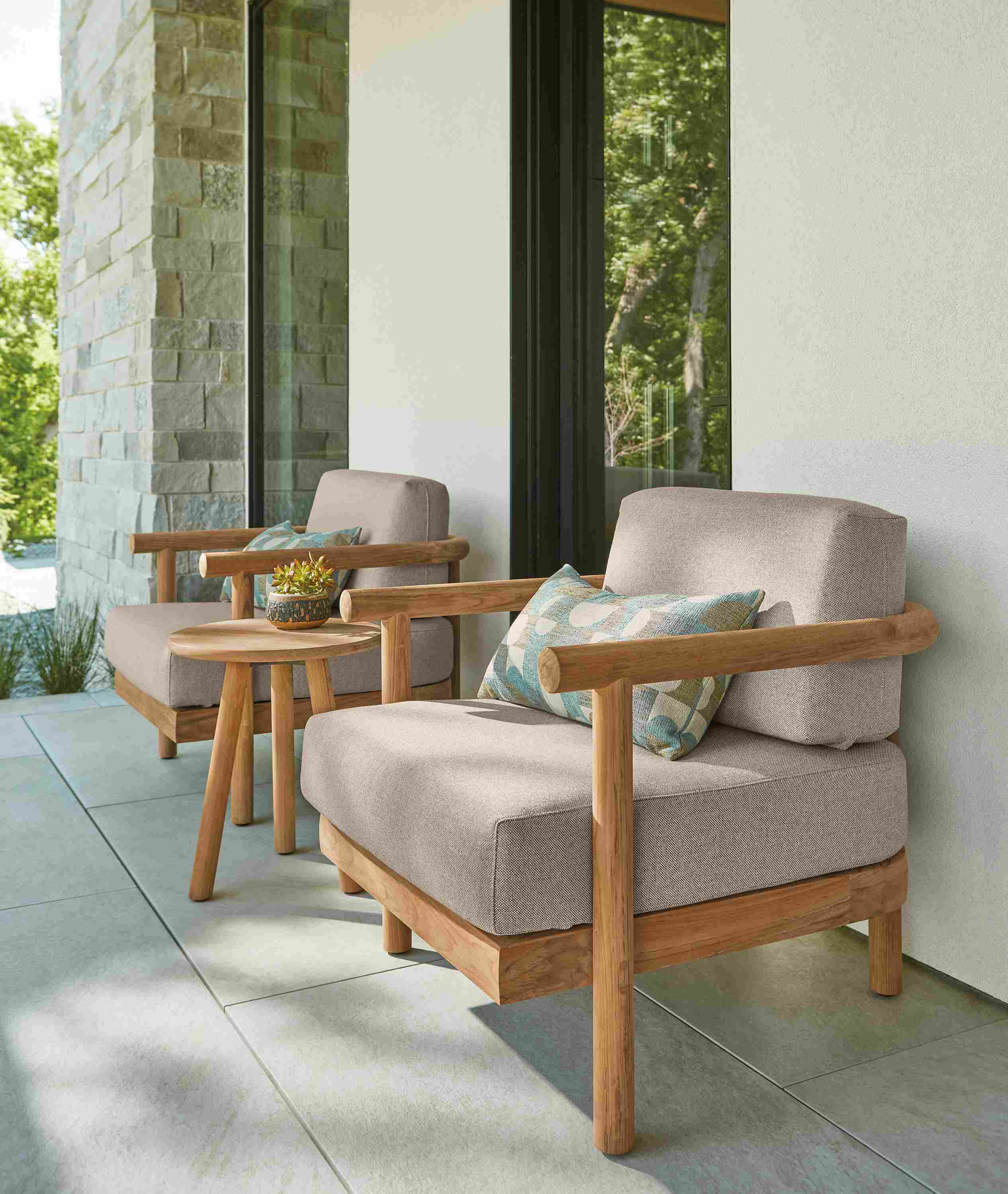Patio with 2 Isley lounge chairs in Mist Oatmeal and Teak heartwood and Isley 17-diameter coffee table in teak heartwood.